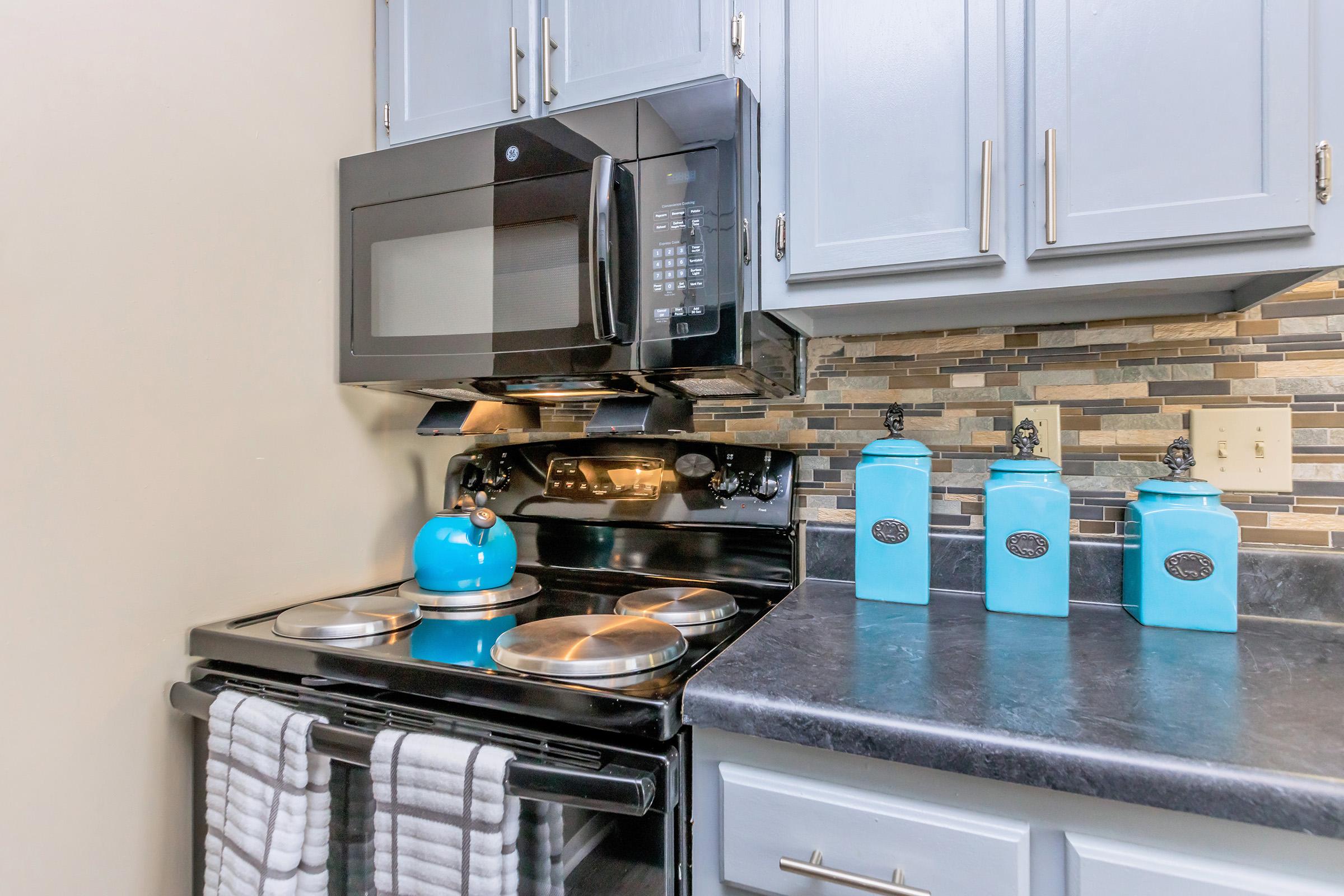 a stove top oven sitting inside of a kitchen