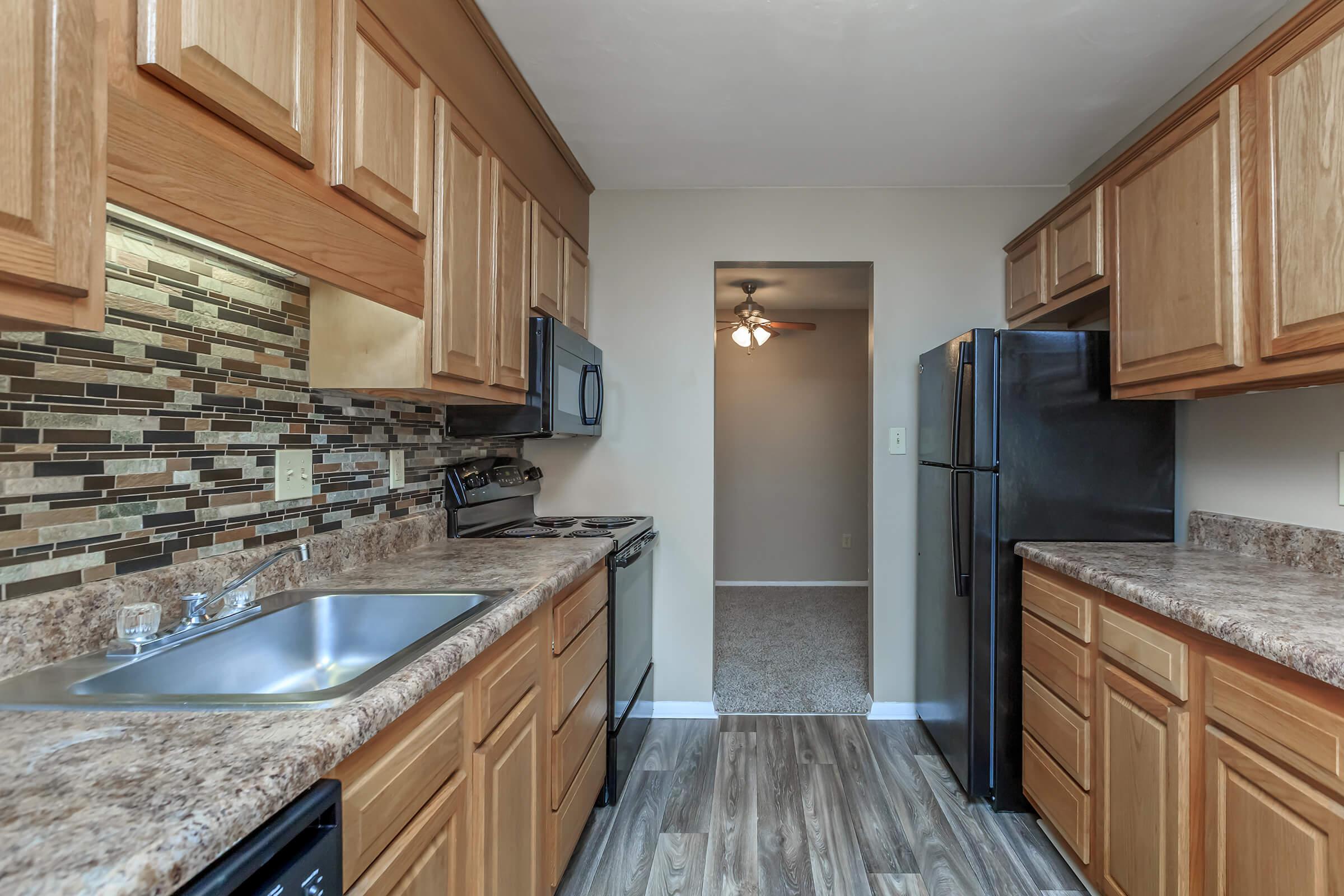 a modern kitchen with stainless steel appliances and wooden cabinets