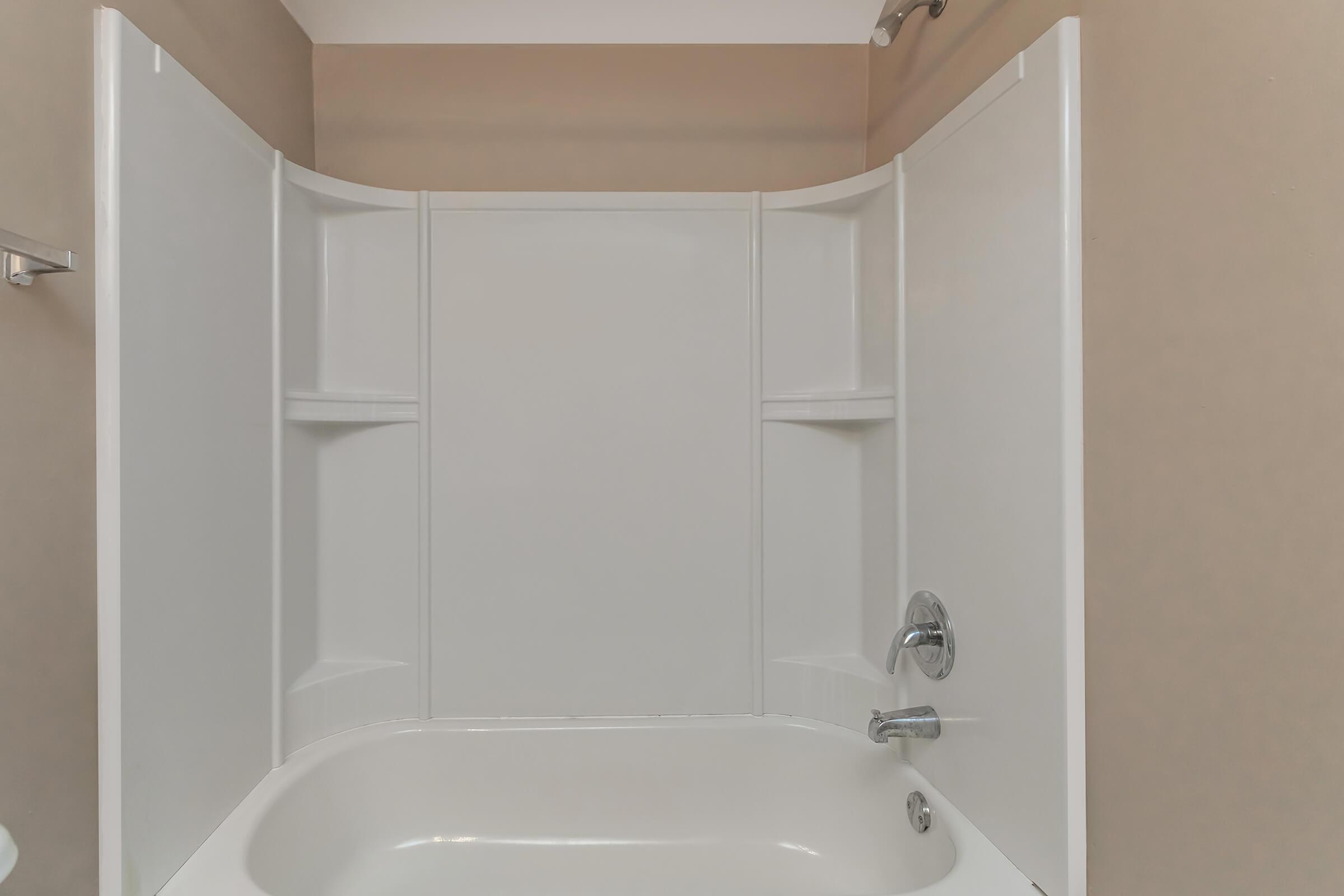 a white tub sitting next to a shower