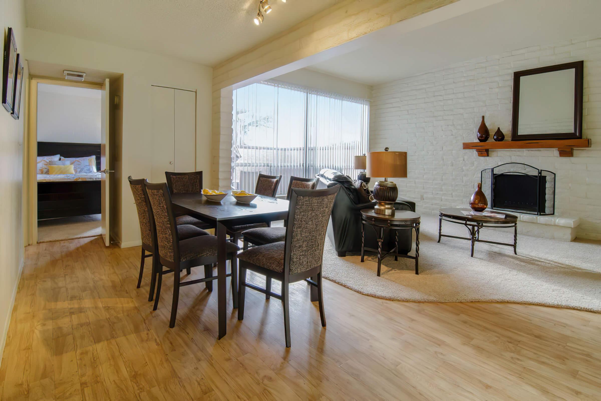 a living room filled with furniture and a wood floor