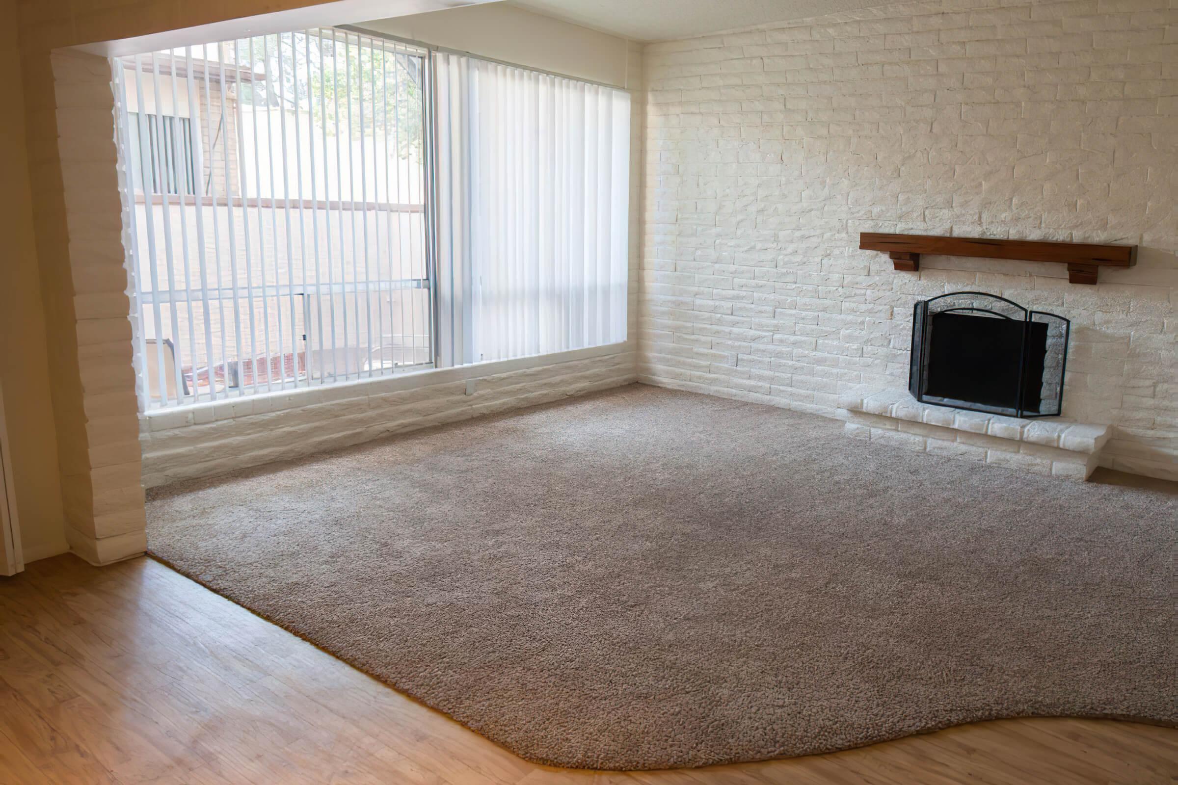 a room with a fireplace and a large window