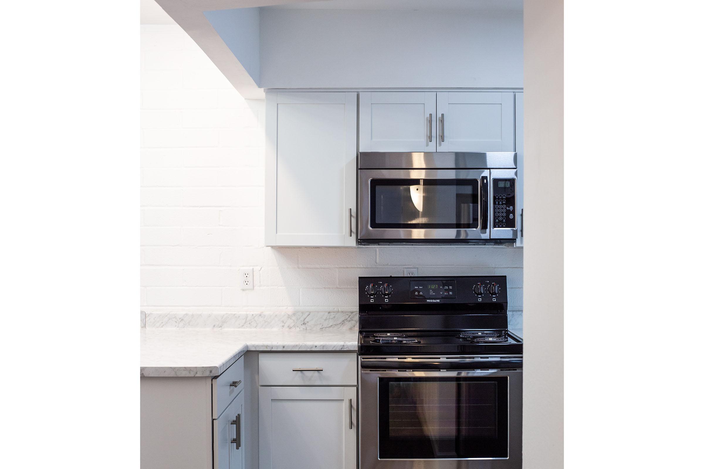 a stove top oven sitting inside of a kitchen