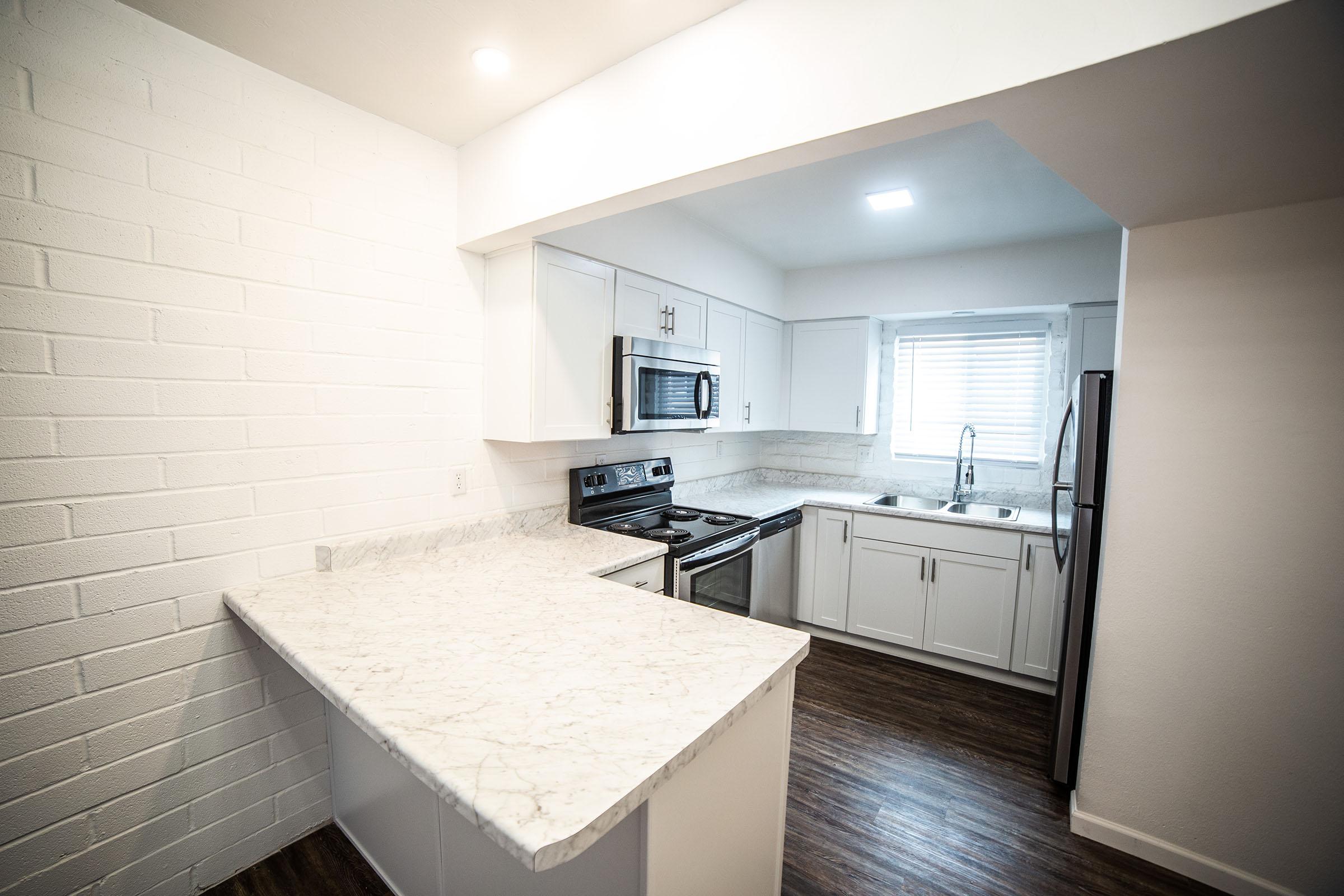 a kitchen with a sink and a mirror