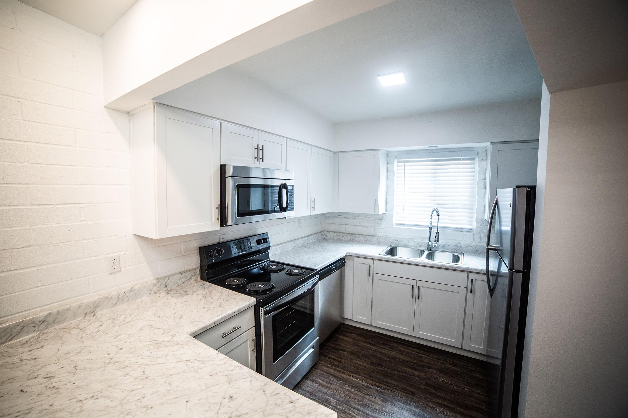 a kitchen with a stove sink and refrigerator