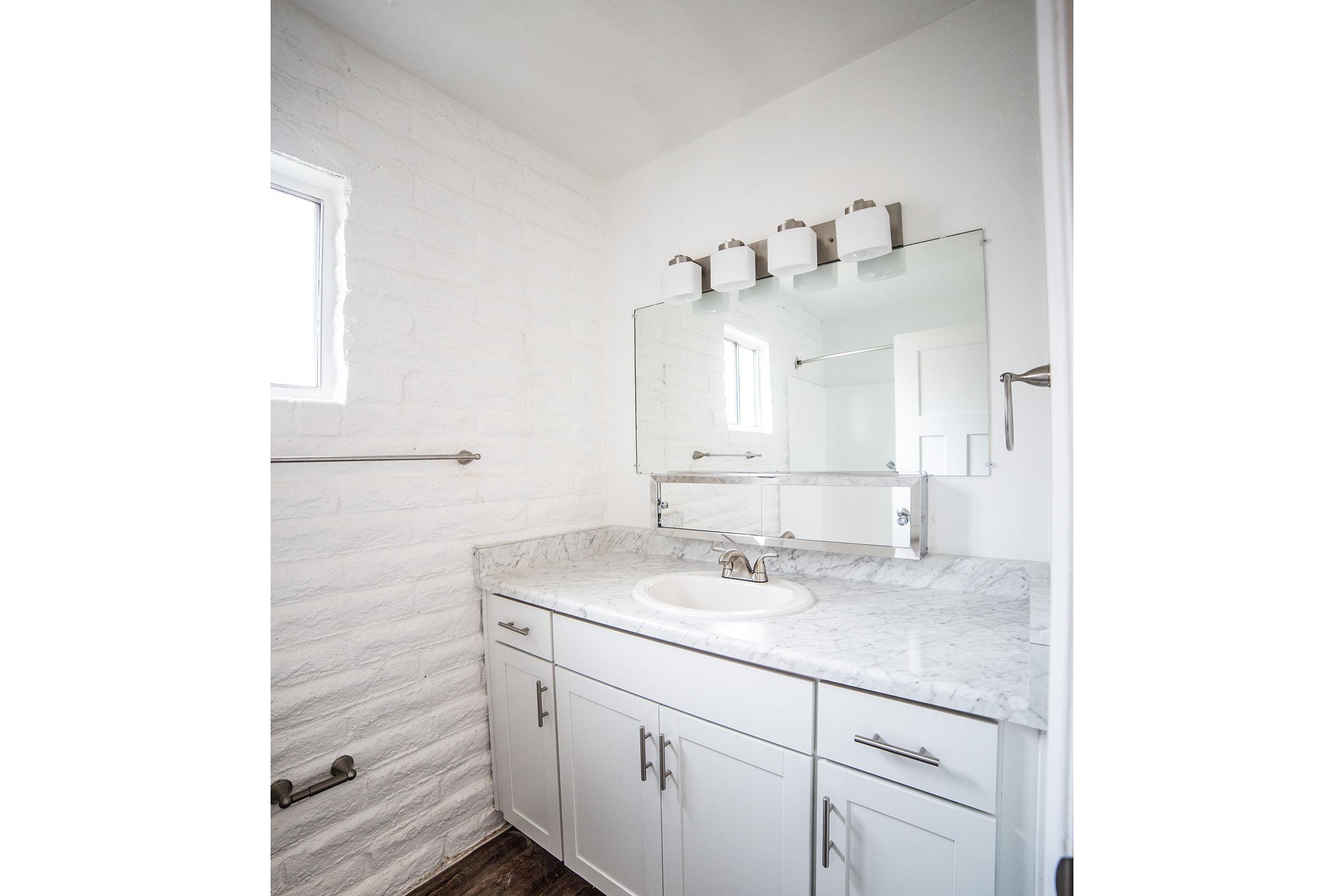 a kitchen with a sink and a mirror