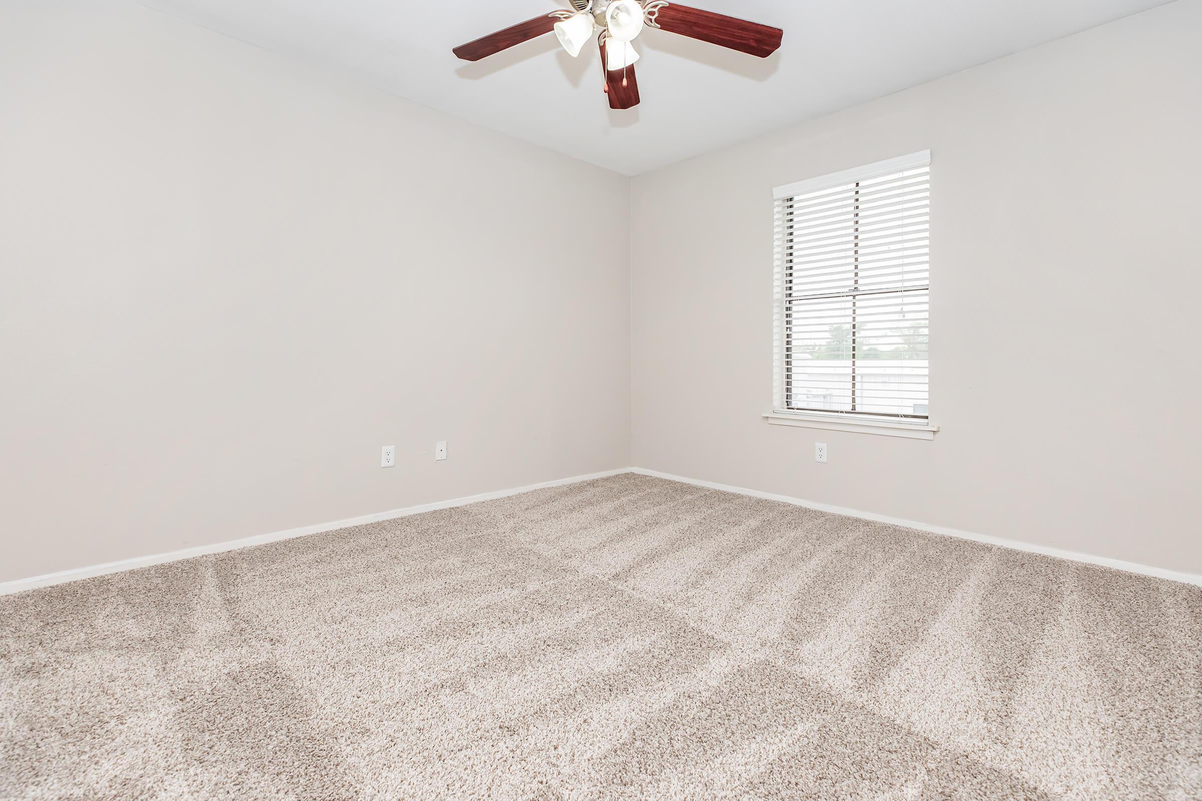 COZY BEDROOM AT THE BRAZOS APARTMENTS IN HUNTSVILLE, TEXAS