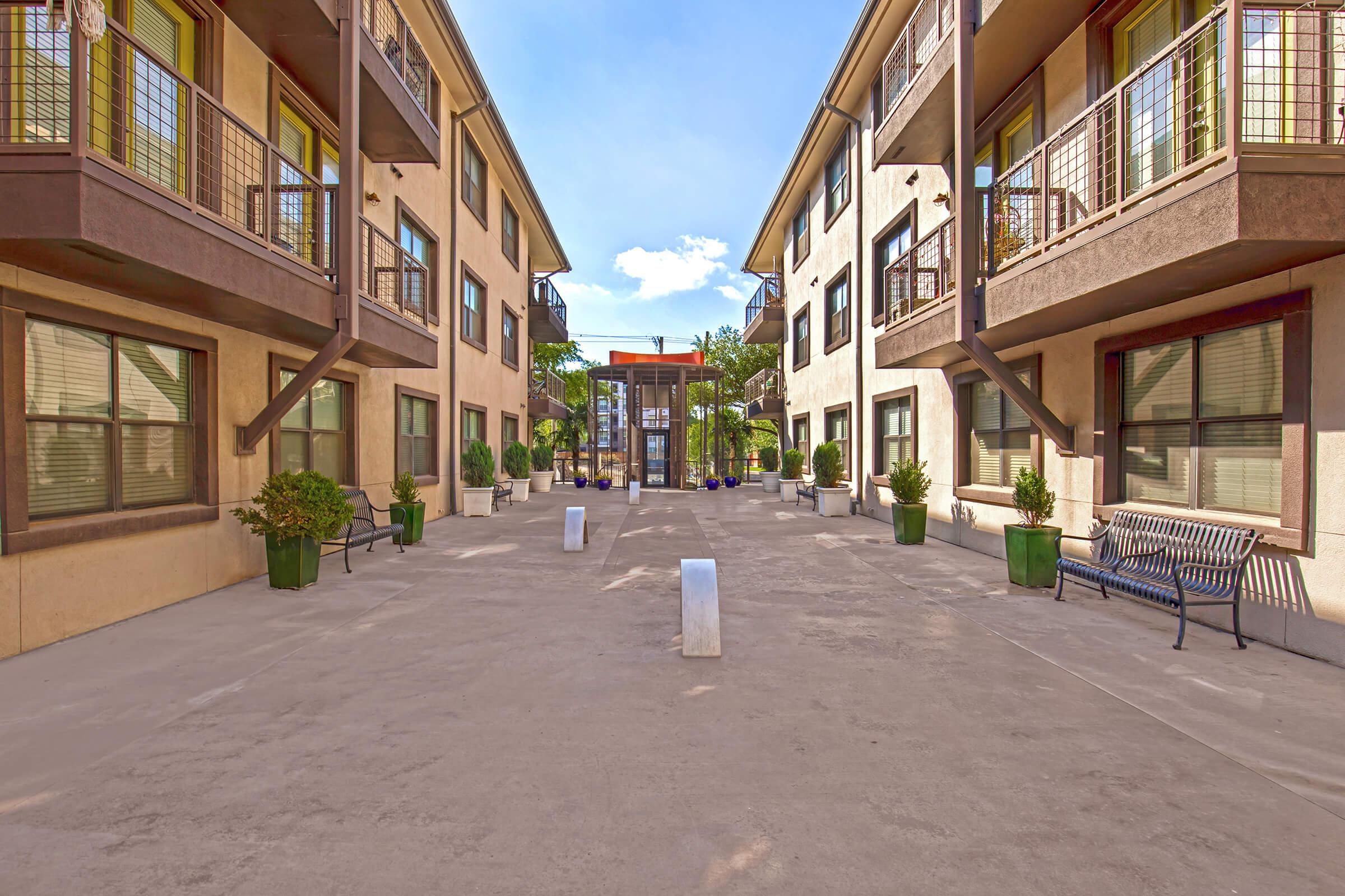 a group of people walking down a street next to a building