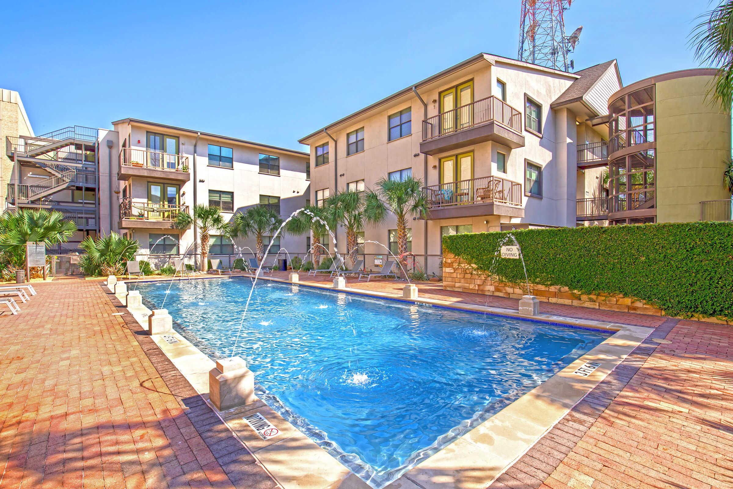 a house with a pool in front of a building