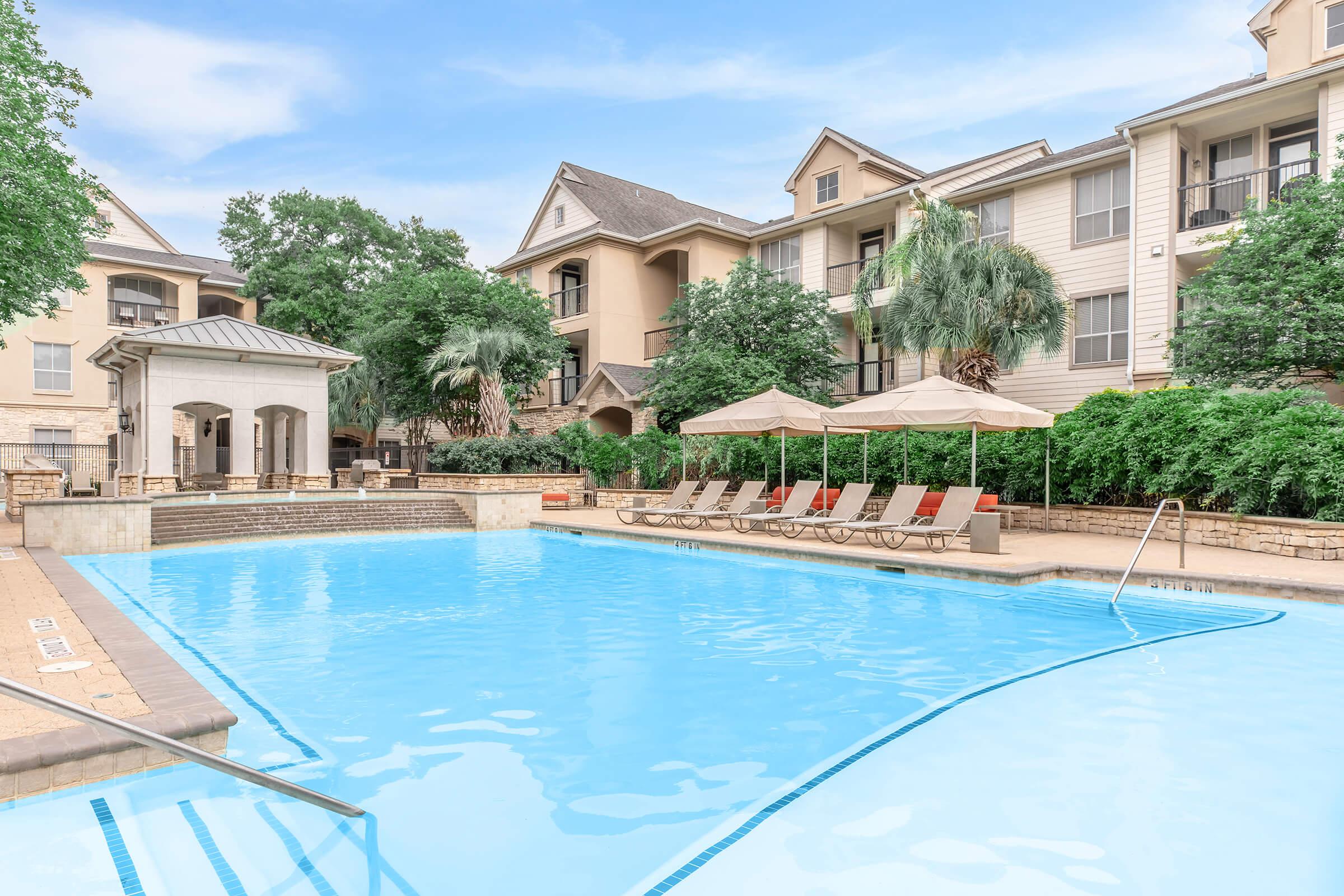 a large pool of water in front of a house