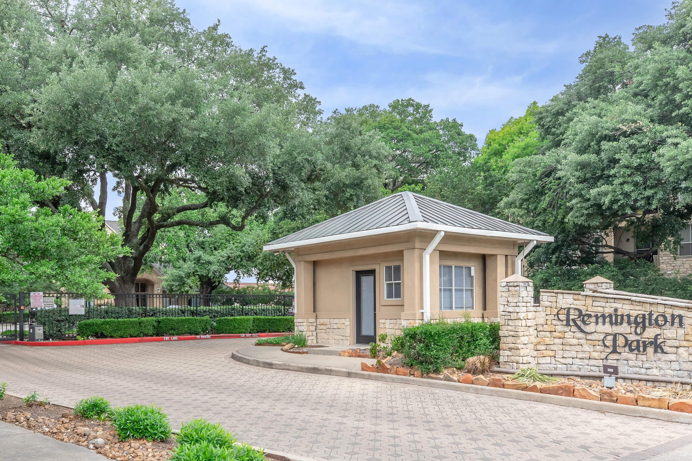 a house with bushes in front of a building