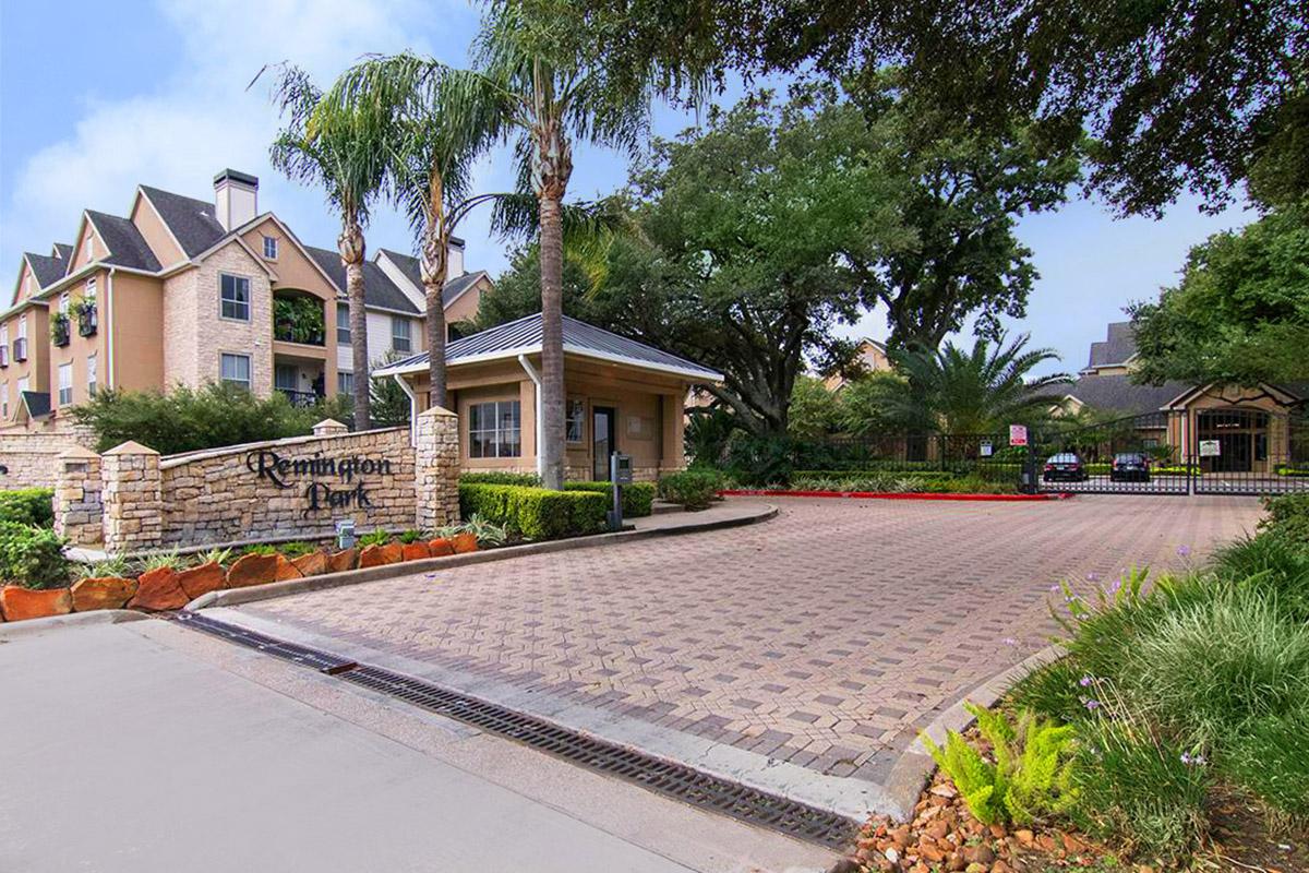 a house that has a sign on the side of a road