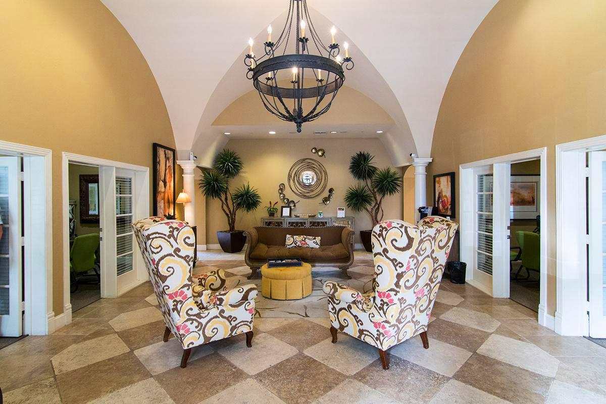 a living room filled with furniture and vase of flowers on a table