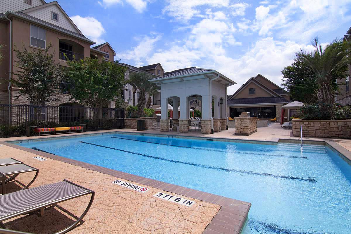 a house with a pool in front of a building