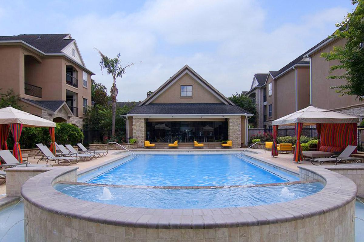 a house with a pool in front of a building