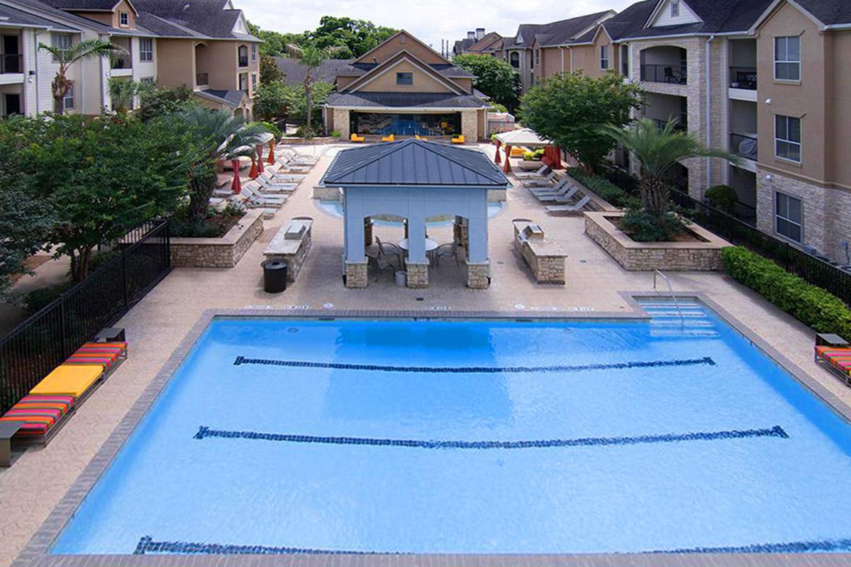 a house with a pool outside of a building