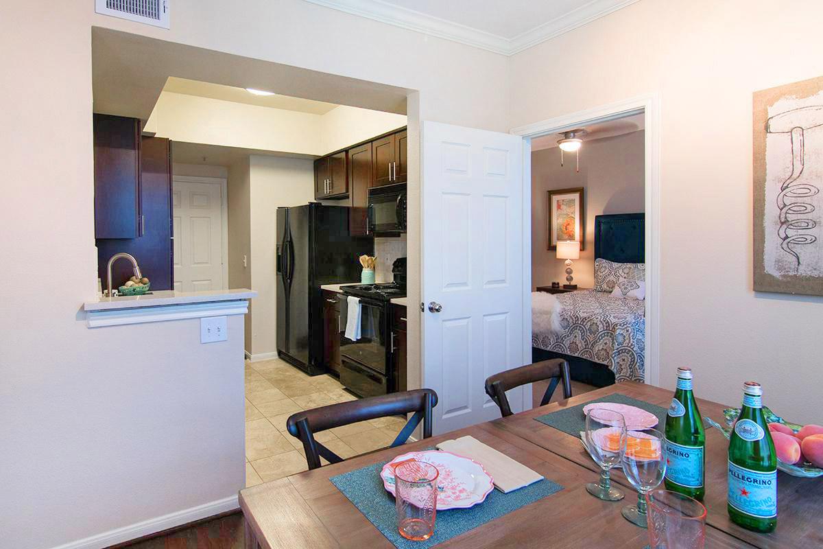 a bedroom with a view of a kitchen