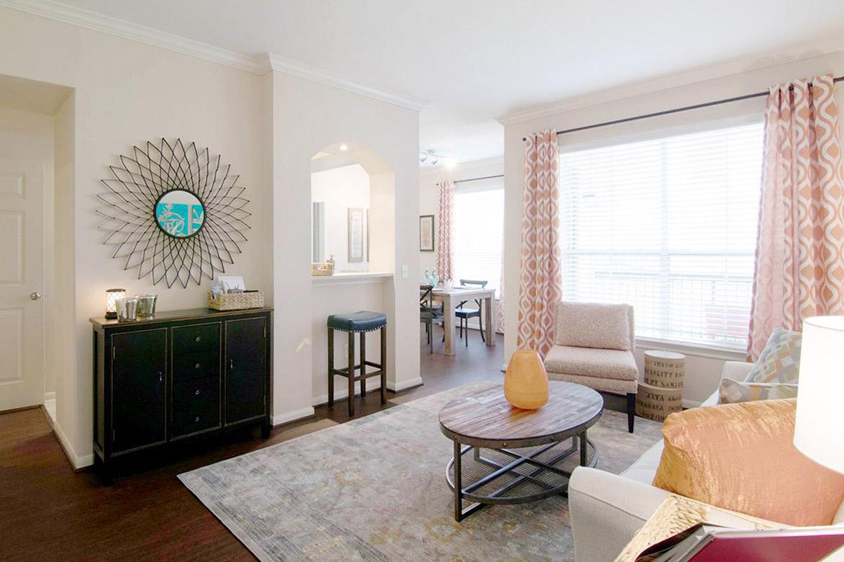 a living room filled with furniture and a large window