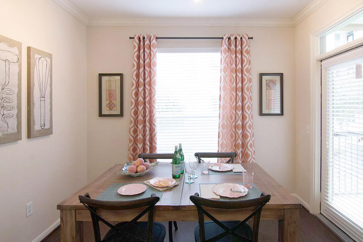 a dining room table in front of a window