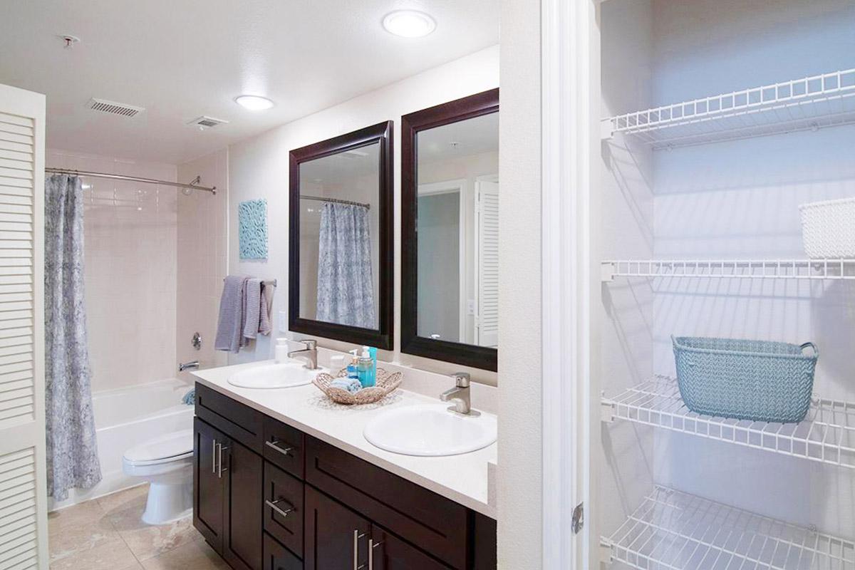 a white sink sitting under a window