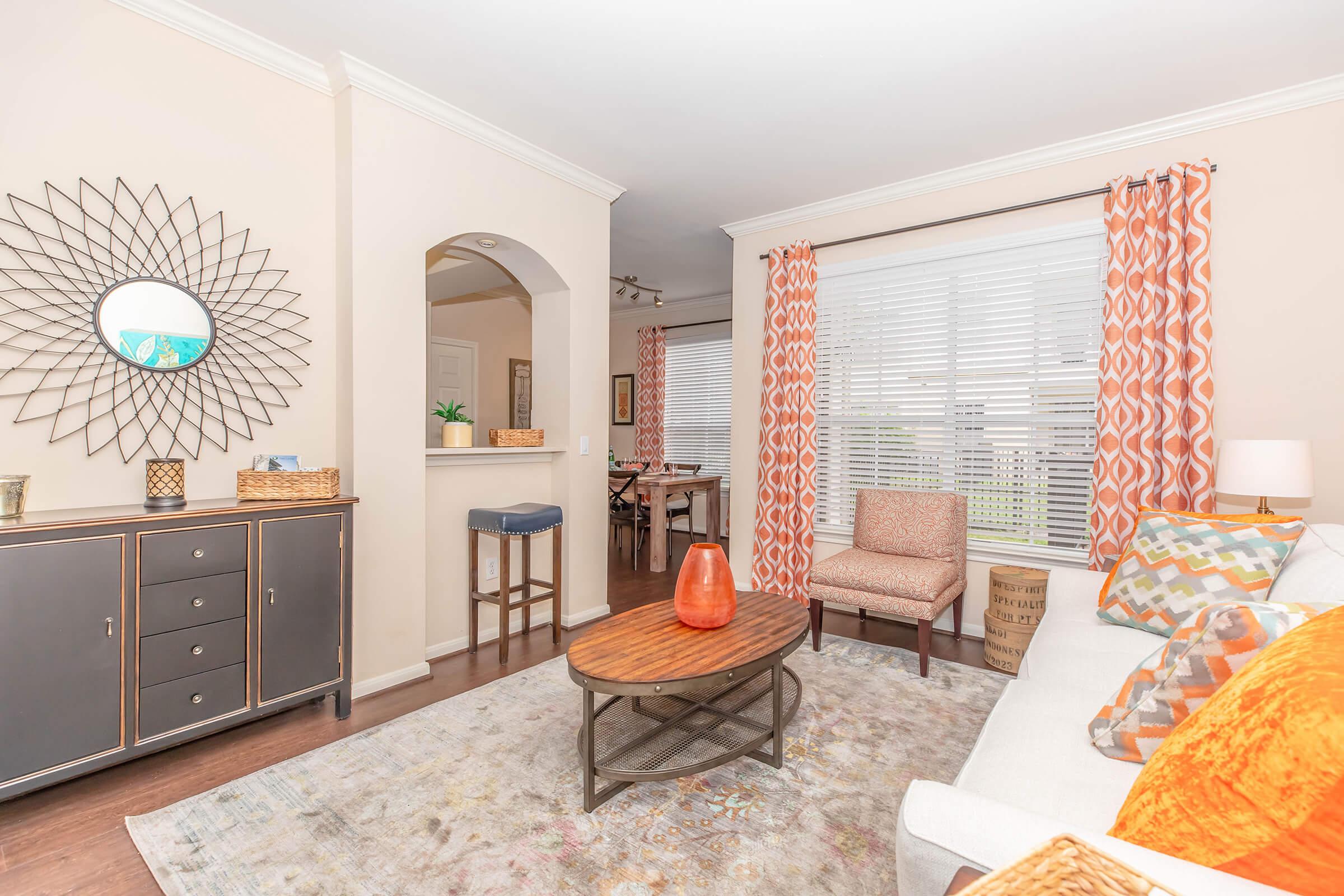 a living room filled with furniture and a large window