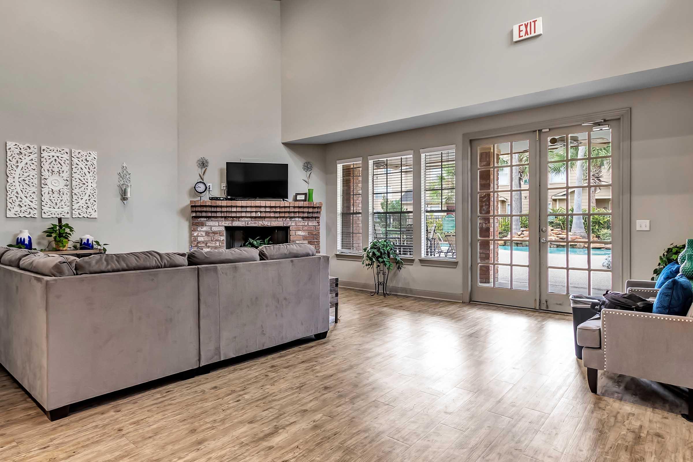 a living room filled with furniture and a large window