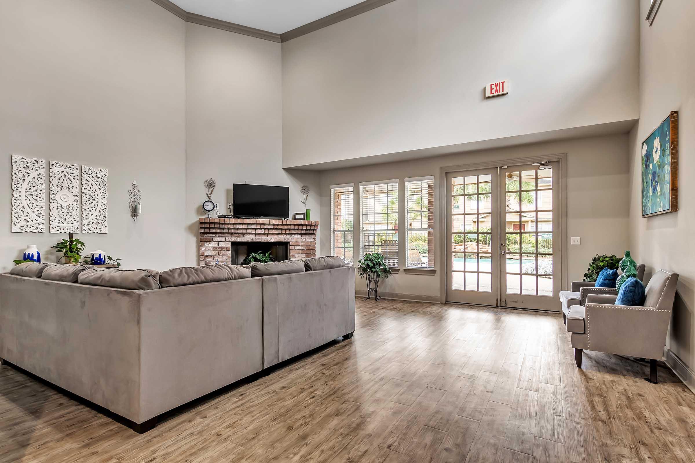 a living room filled with furniture and a large window