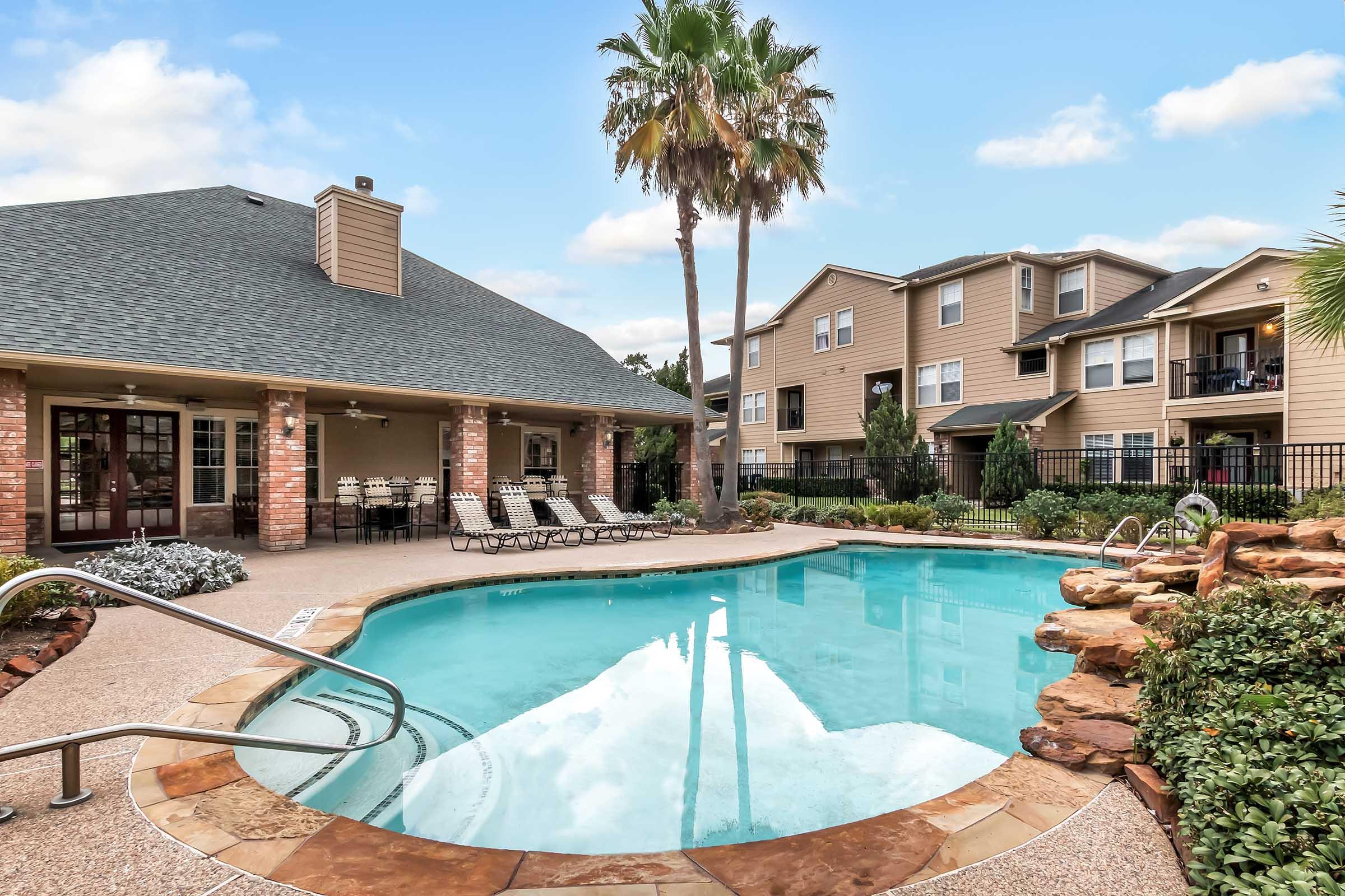 a house with a pool in front of a building