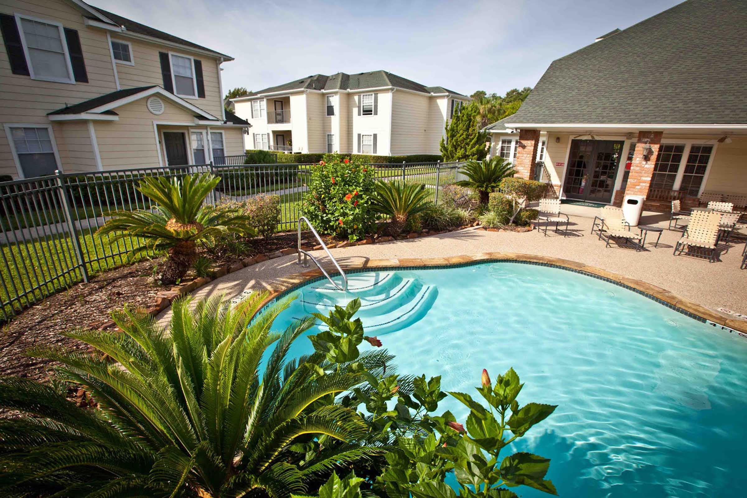 a large pool of water in front of a house