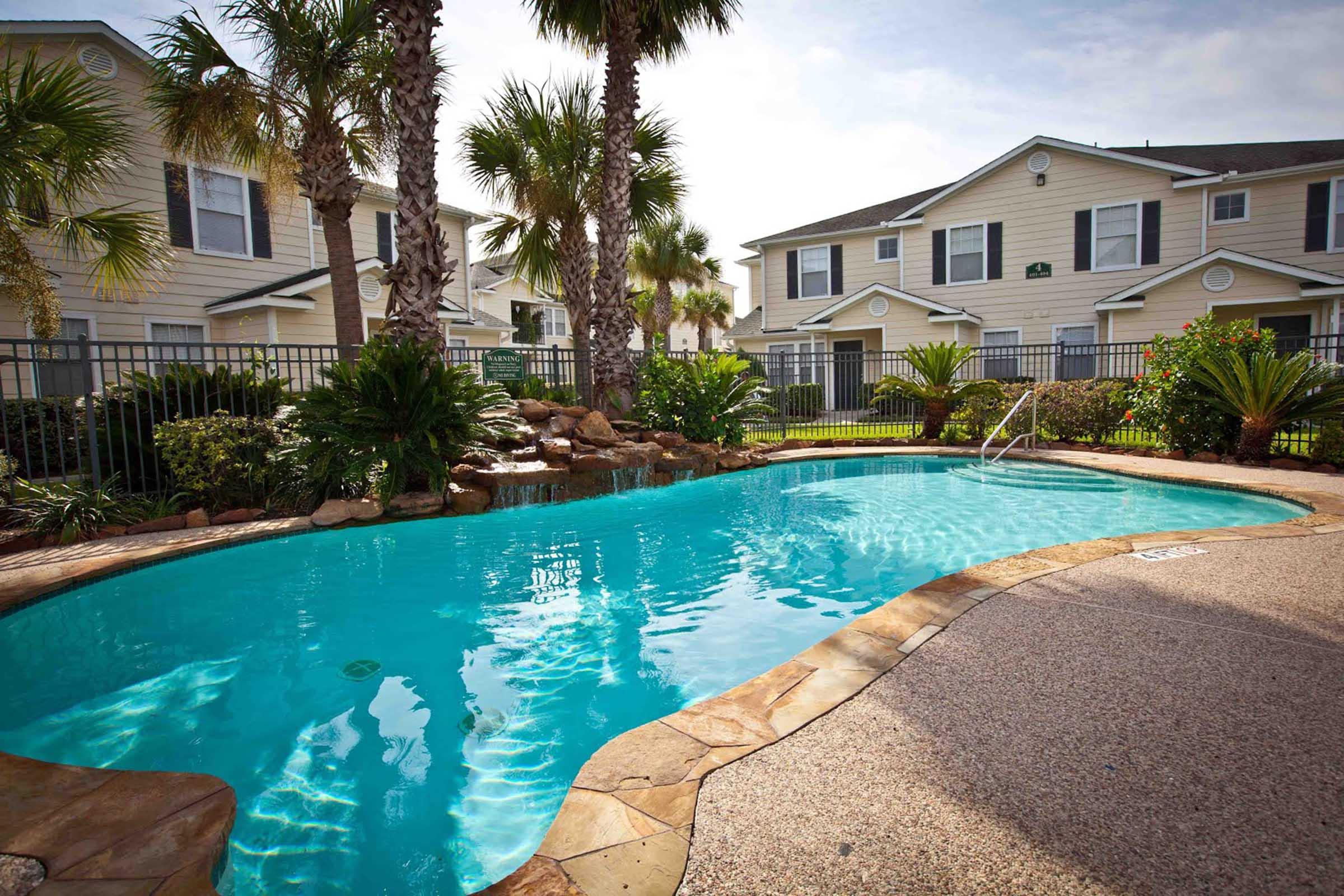 a large pool of water in front of a house