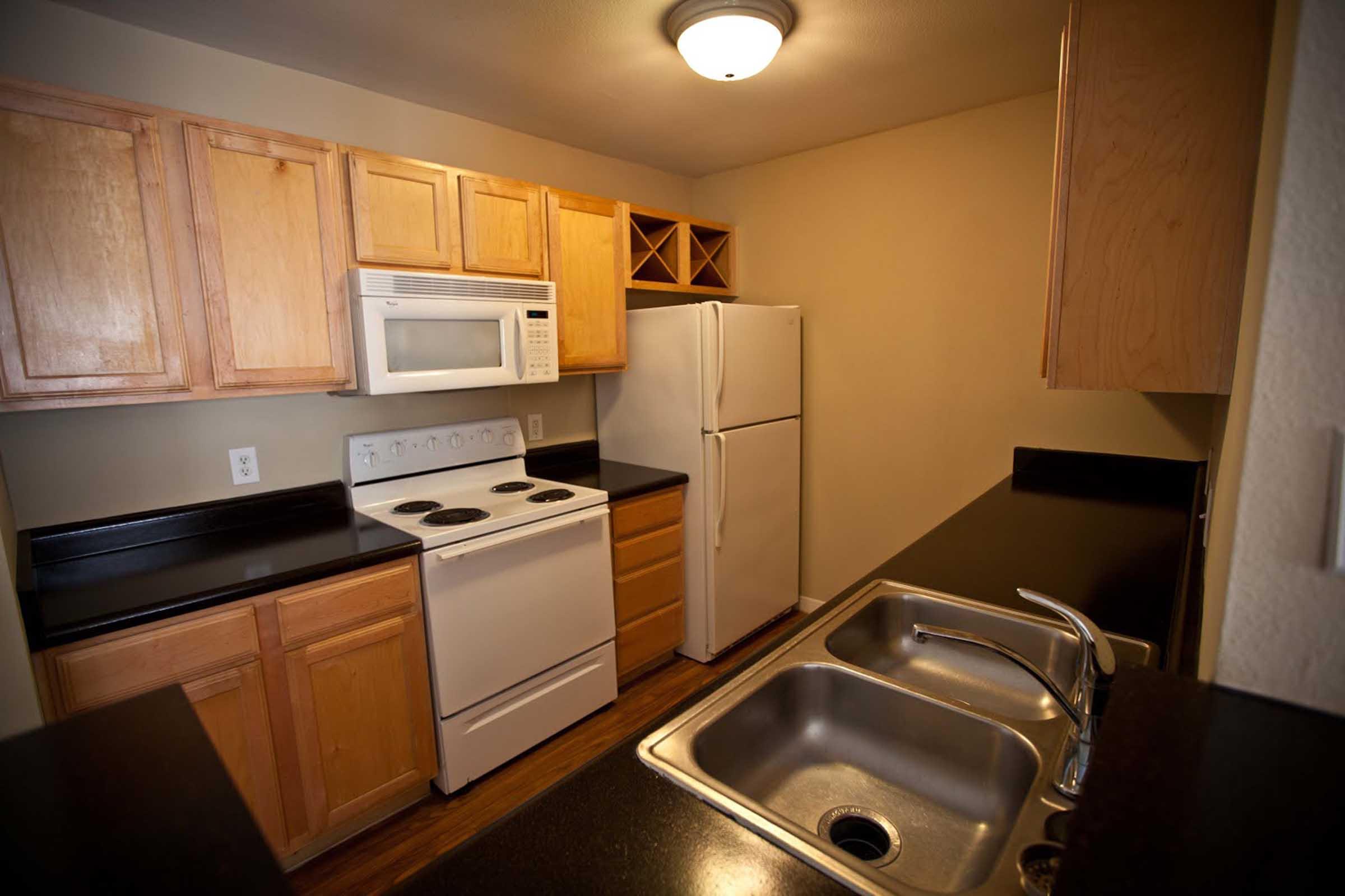 a stove top oven sitting inside of a kitchen