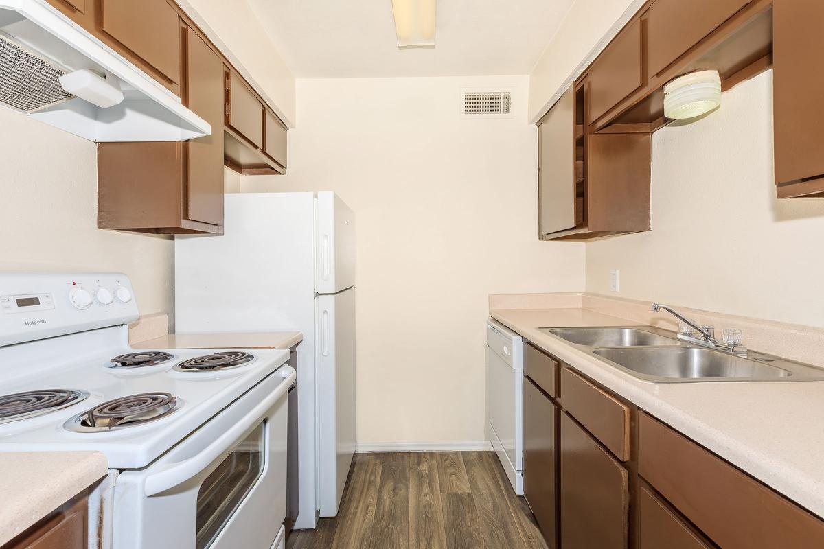 a kitchen with a stove sink and refrigerator