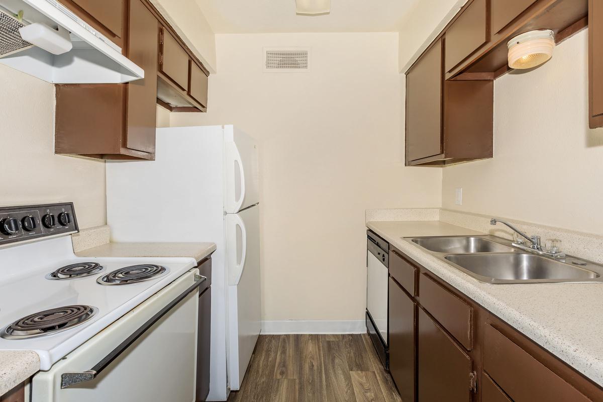 a kitchen with a stove sink and refrigerator