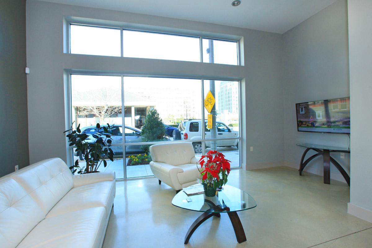 a living room filled with furniture and a large window