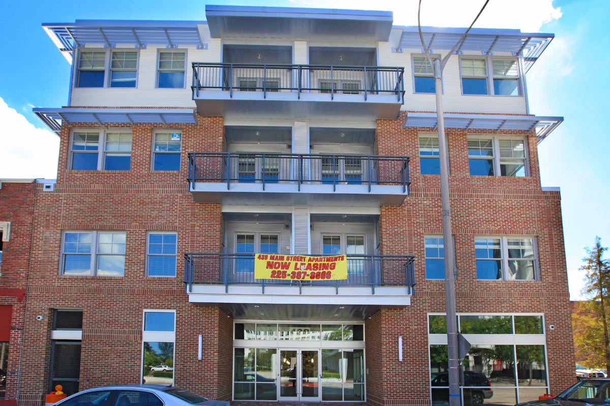a sign in front of a brick building