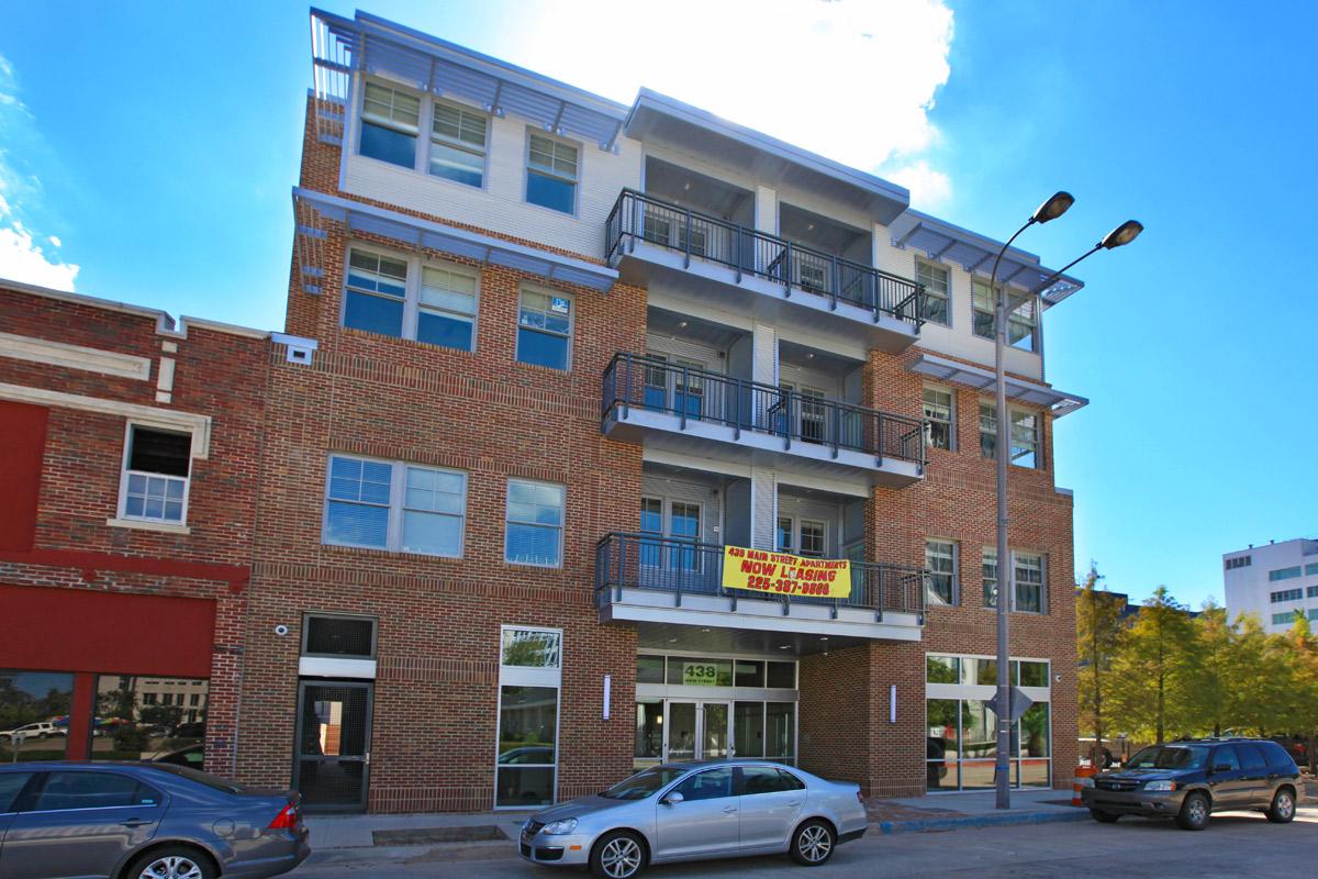 a car parked in front of a brick building