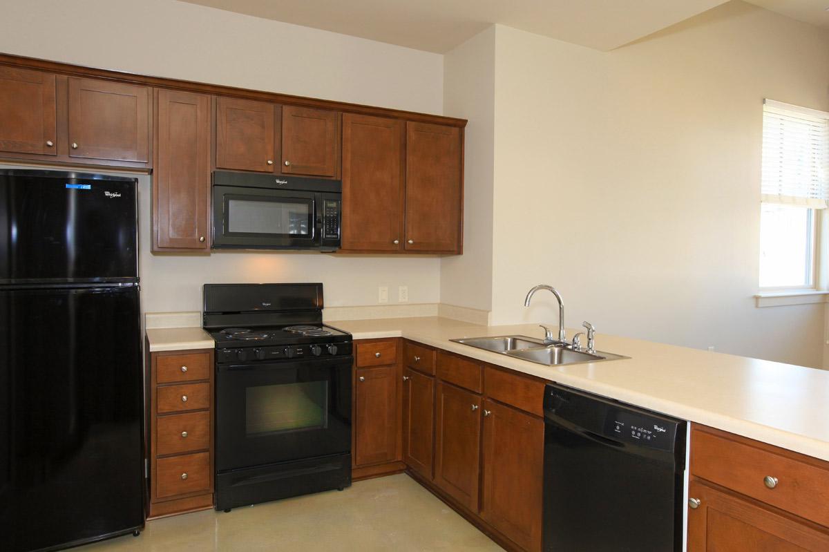 a kitchen with stainless steel appliances and wooden cabinets