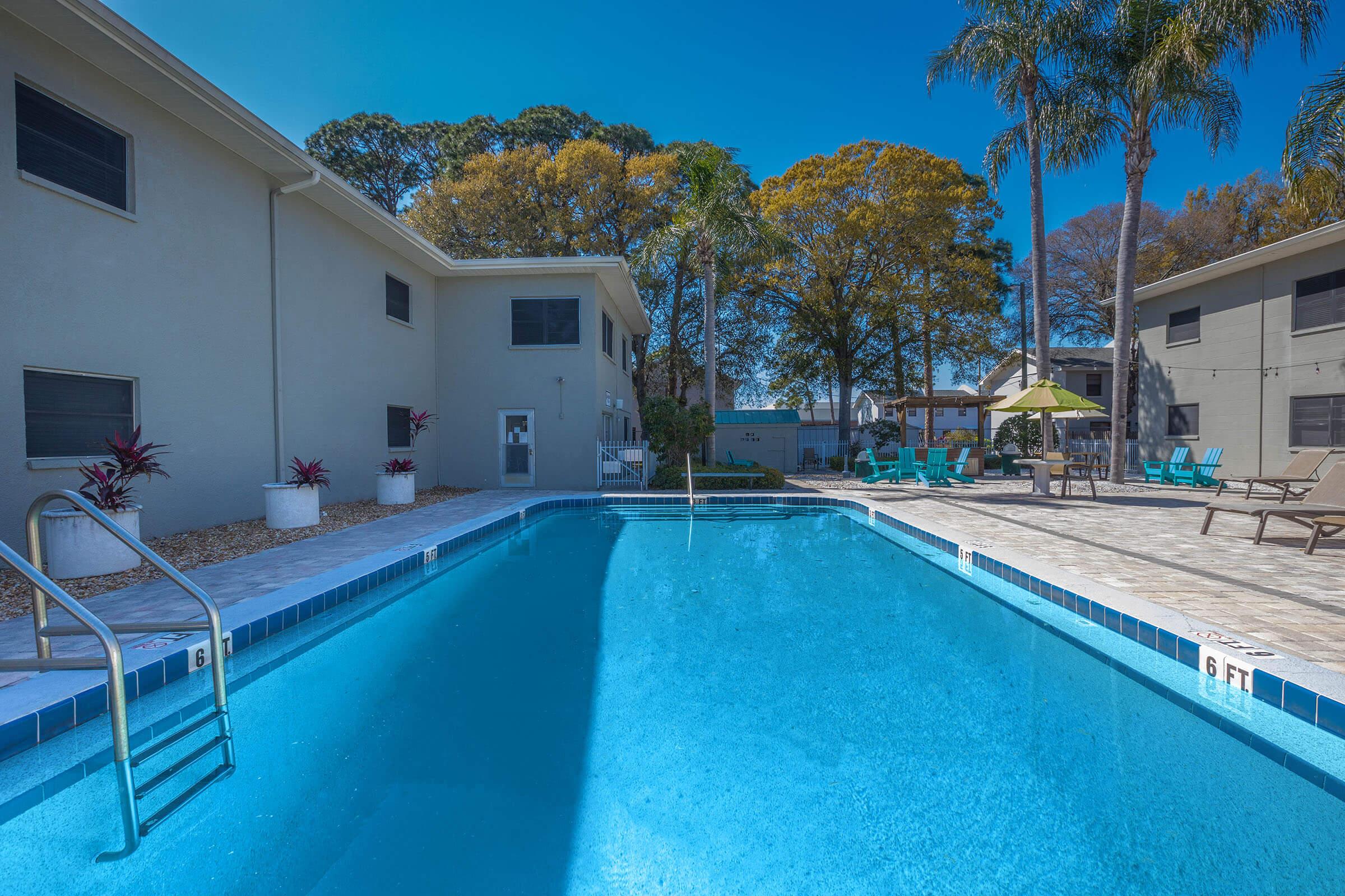 a house with a pool outside of a building