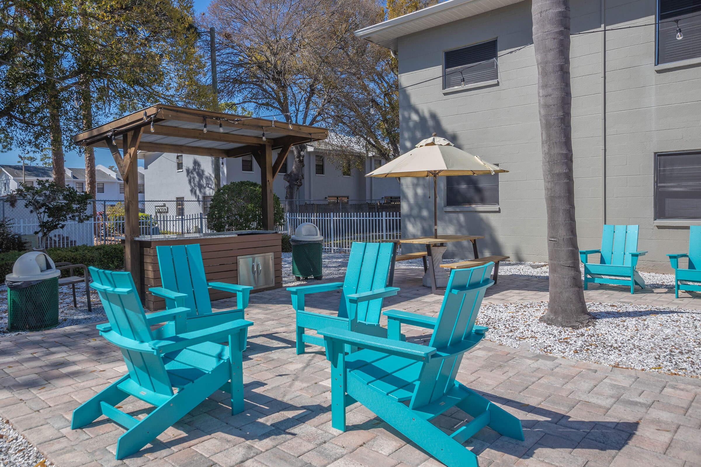 a group of lawn chairs sitting on top of a picnic table