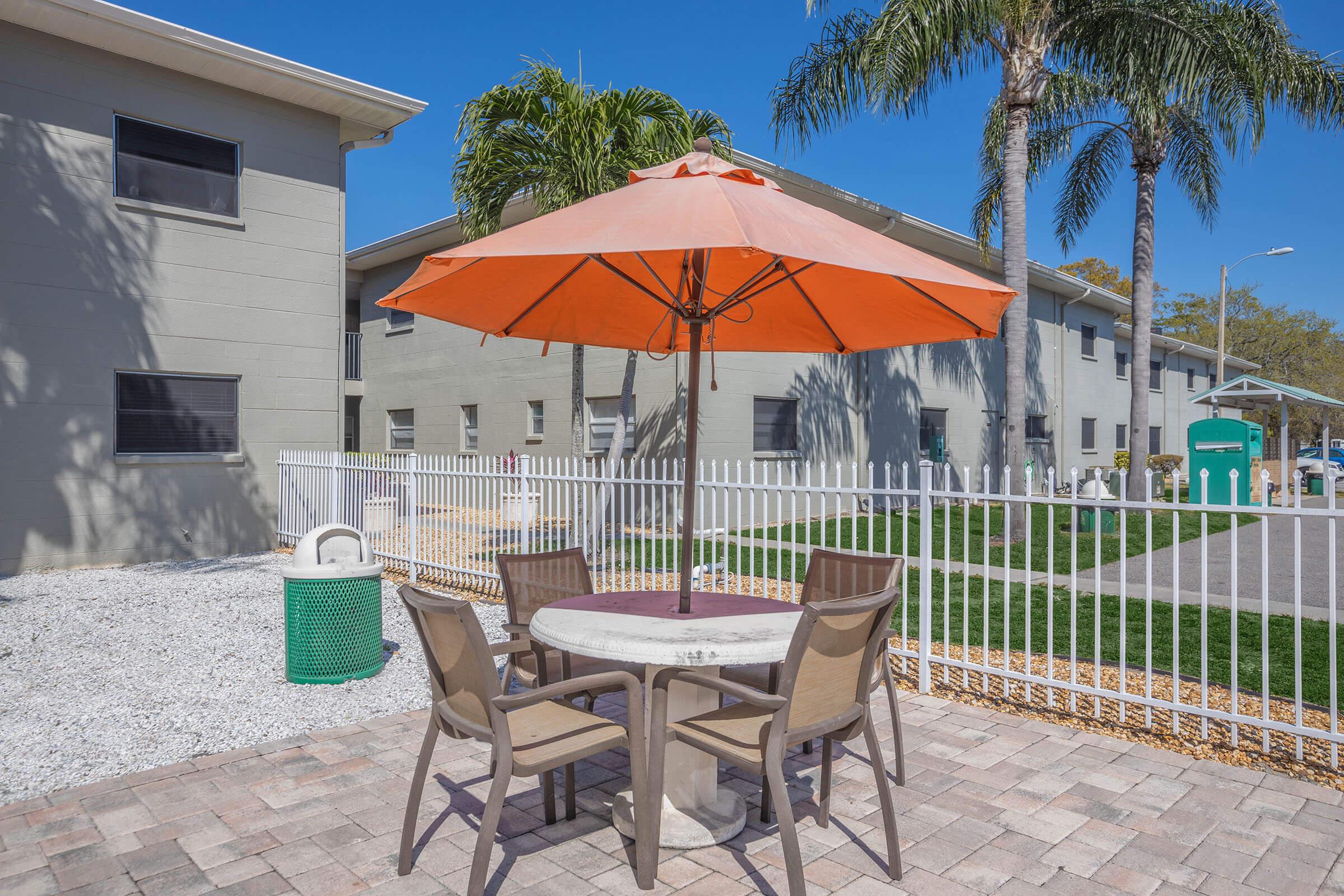 a green lawn chair with an umbrella