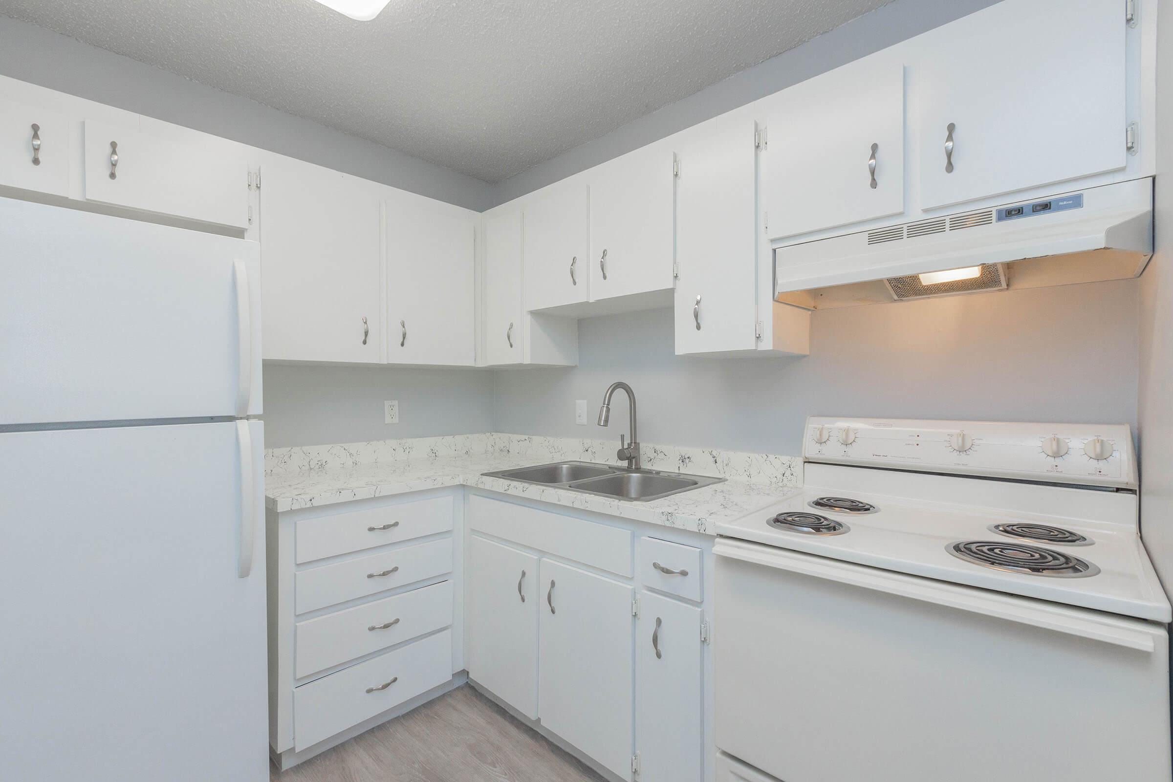 a kitchen with a stove and a refrigerator