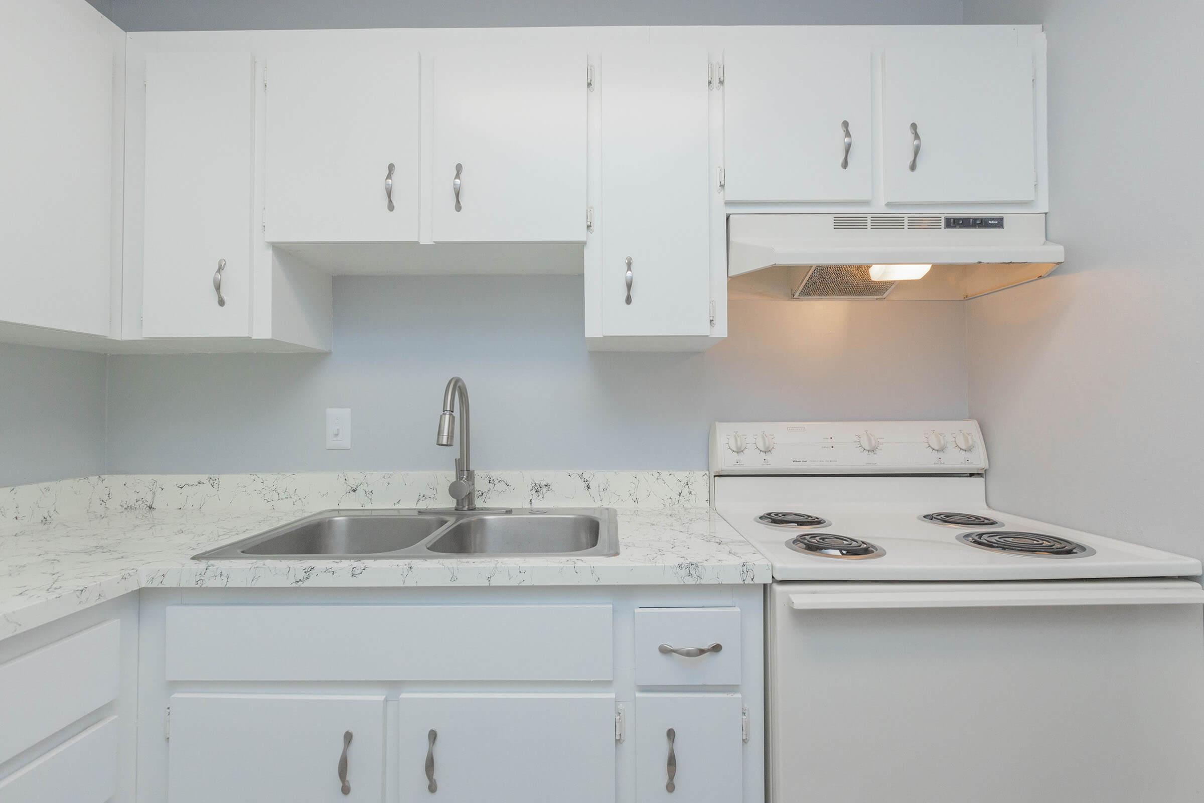 a kitchen with a stove a sink and a microwave