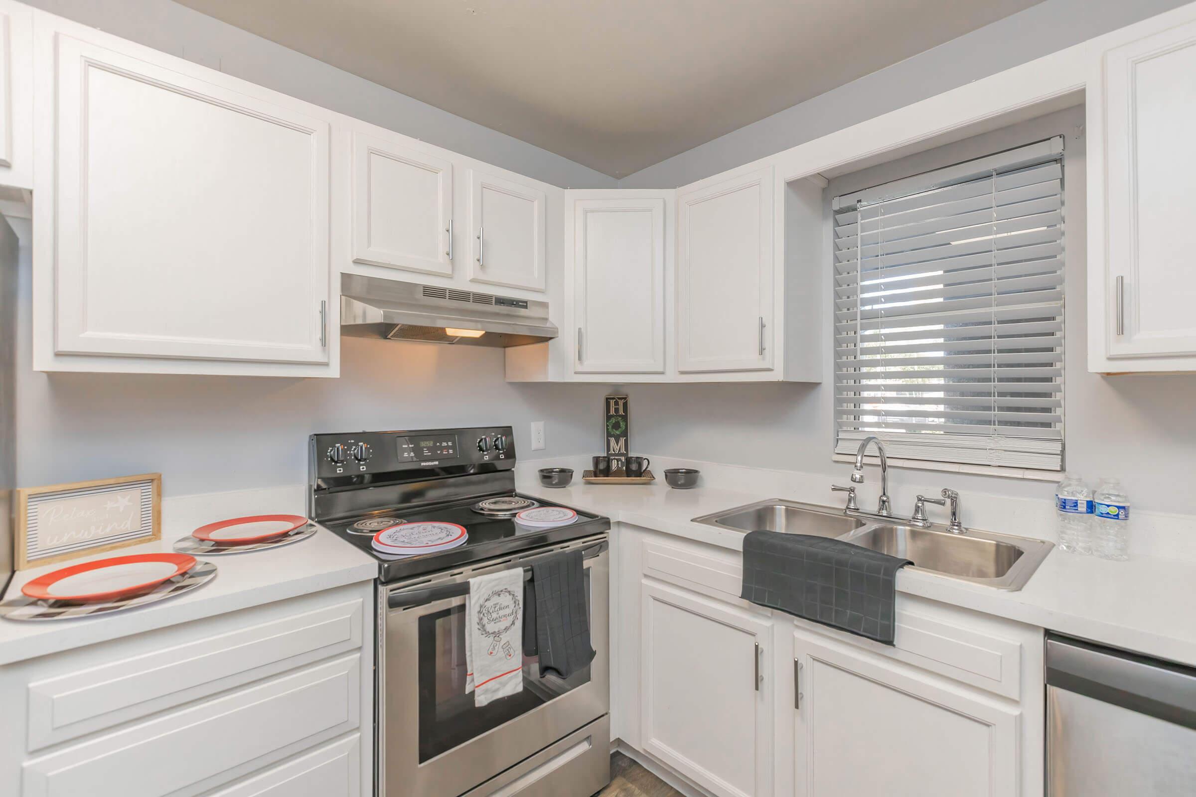 a kitchen with a stove sink and refrigerator