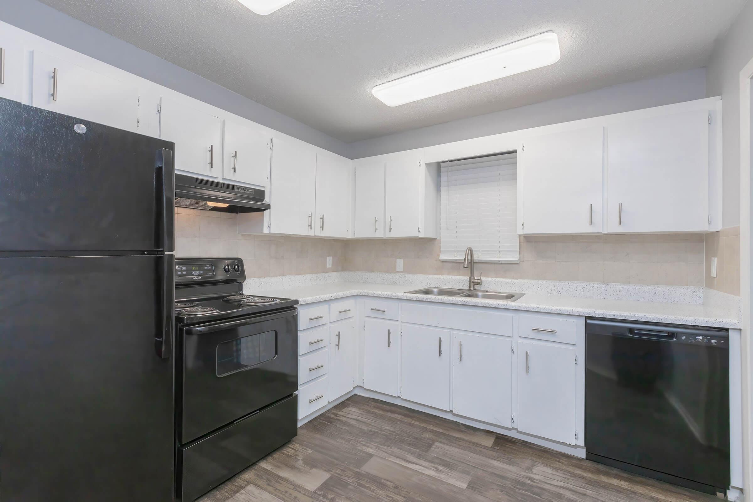 a kitchen with a stove and a refrigerator