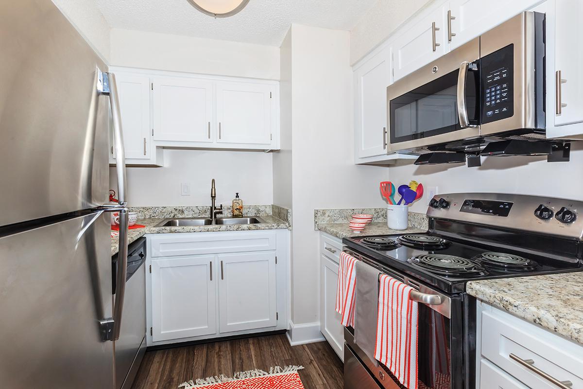 a white stove top oven sitting inside of a kitchen