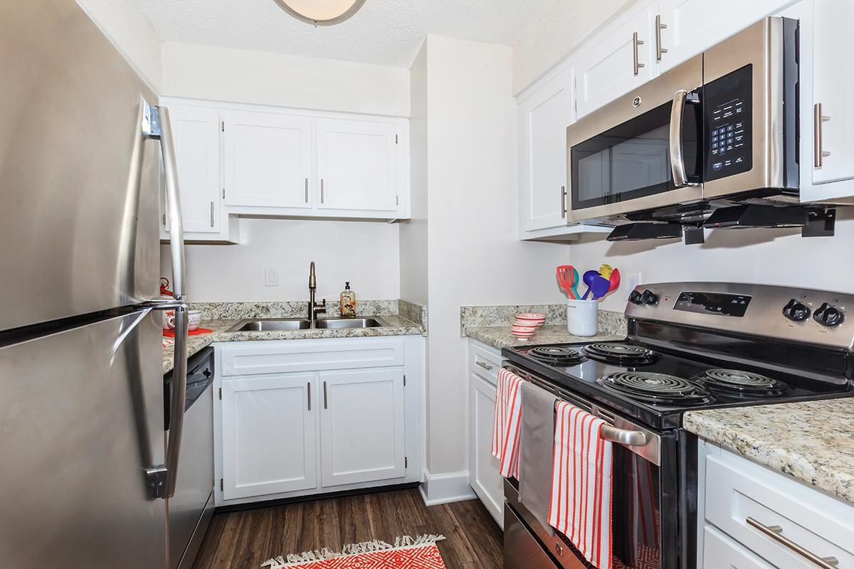a white stove top oven sitting inside of a kitchen