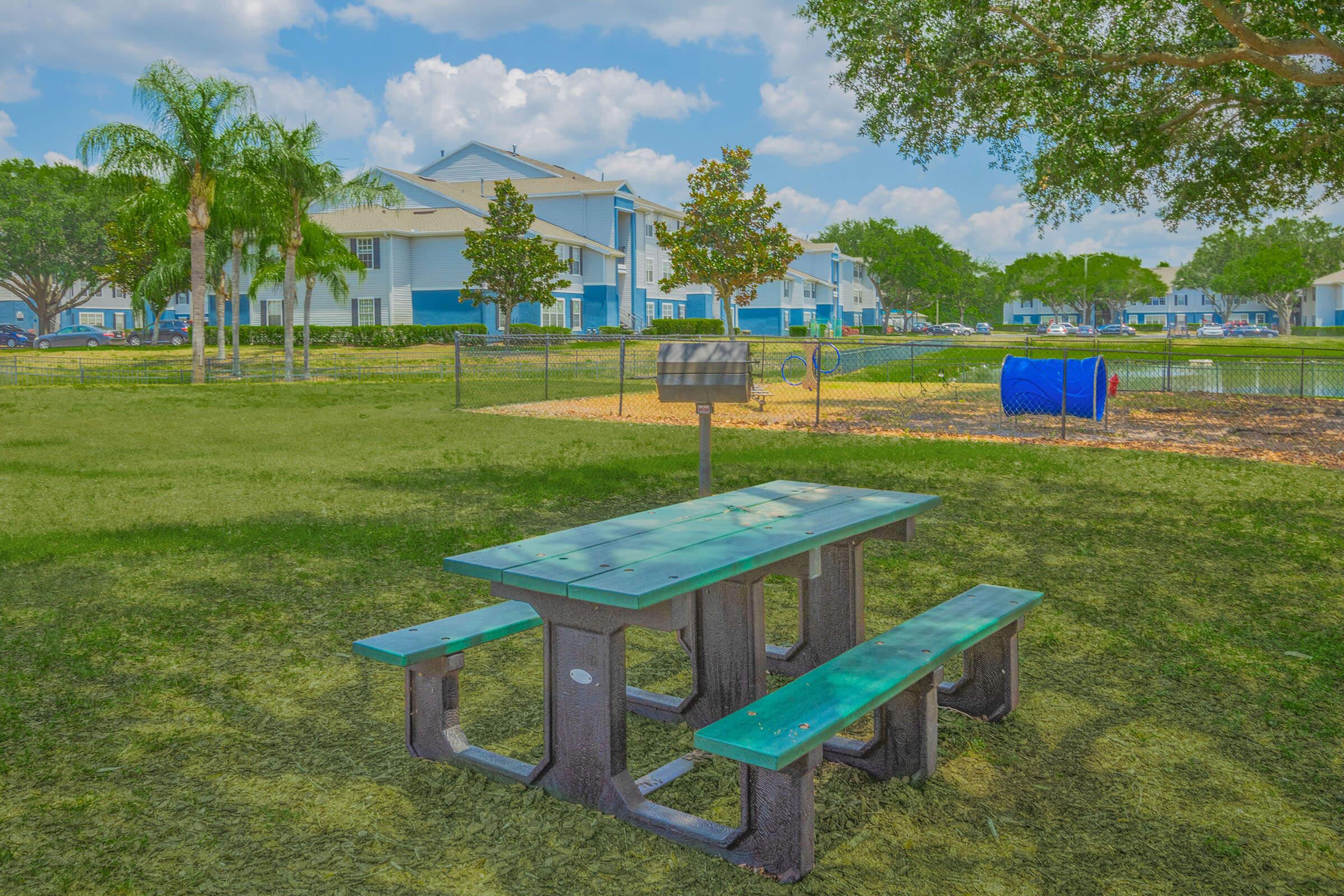 a blue bench in front of a picnic table