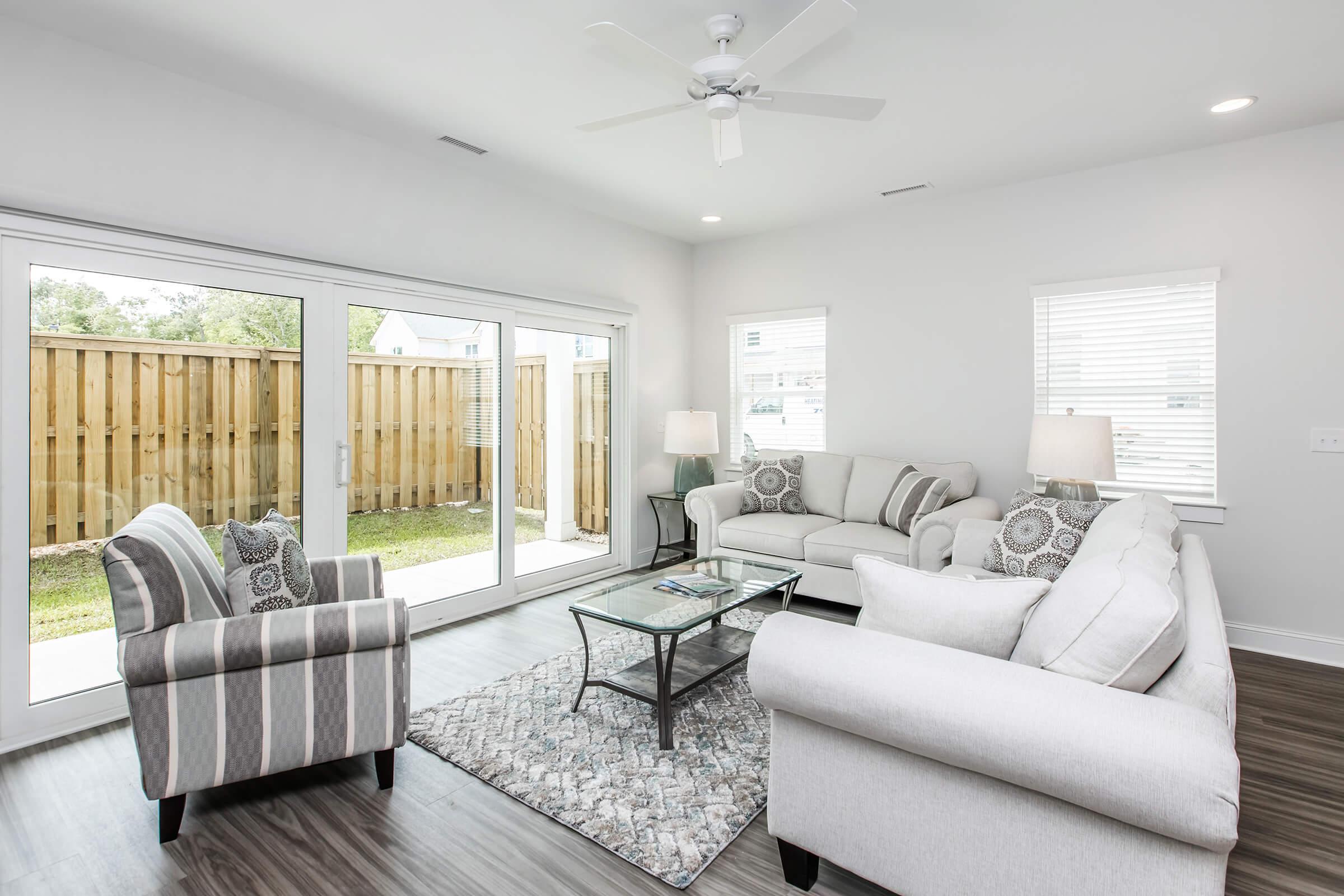 a living room filled with furniture and a large window