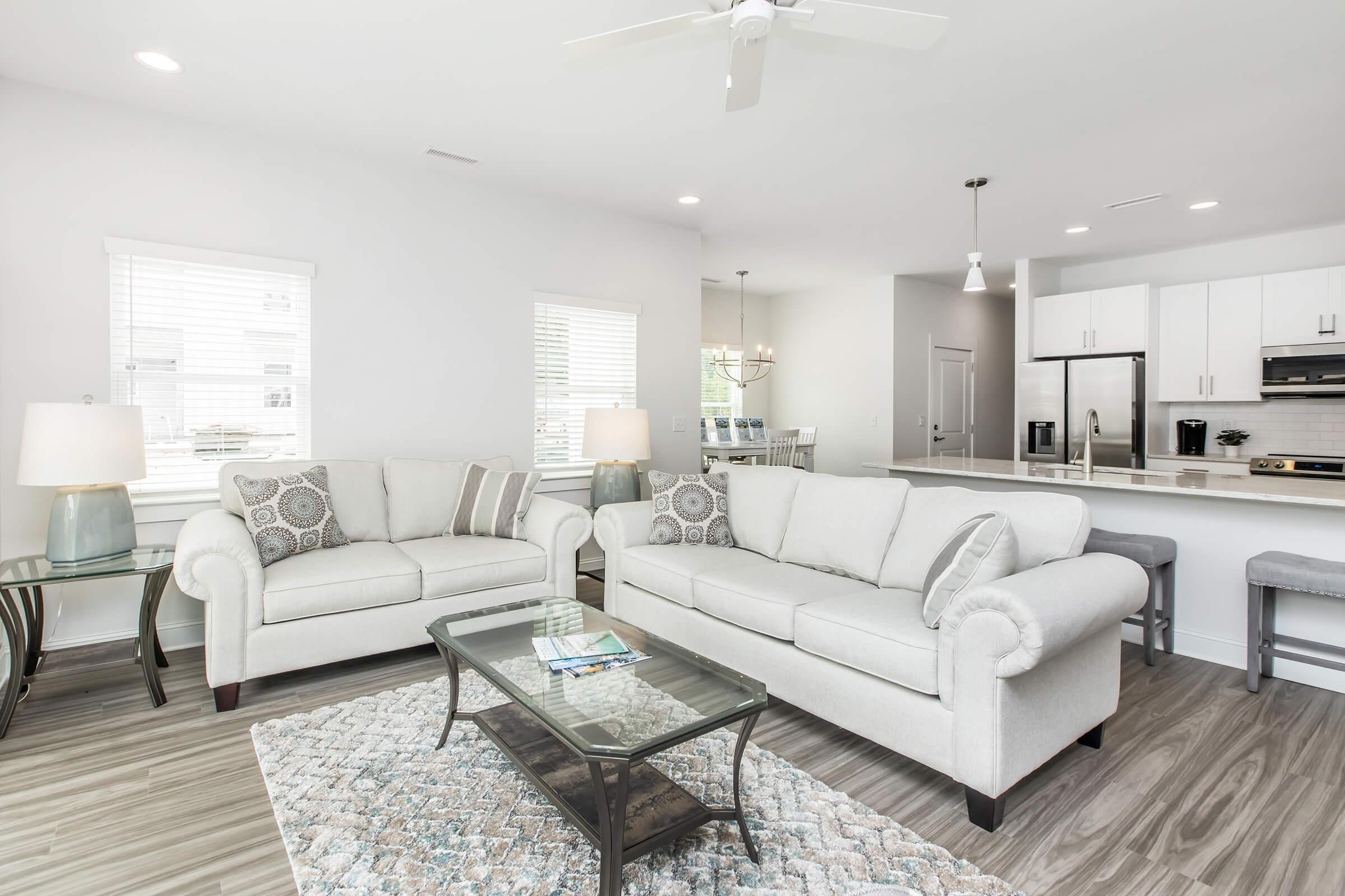 a living room filled with furniture and a large window