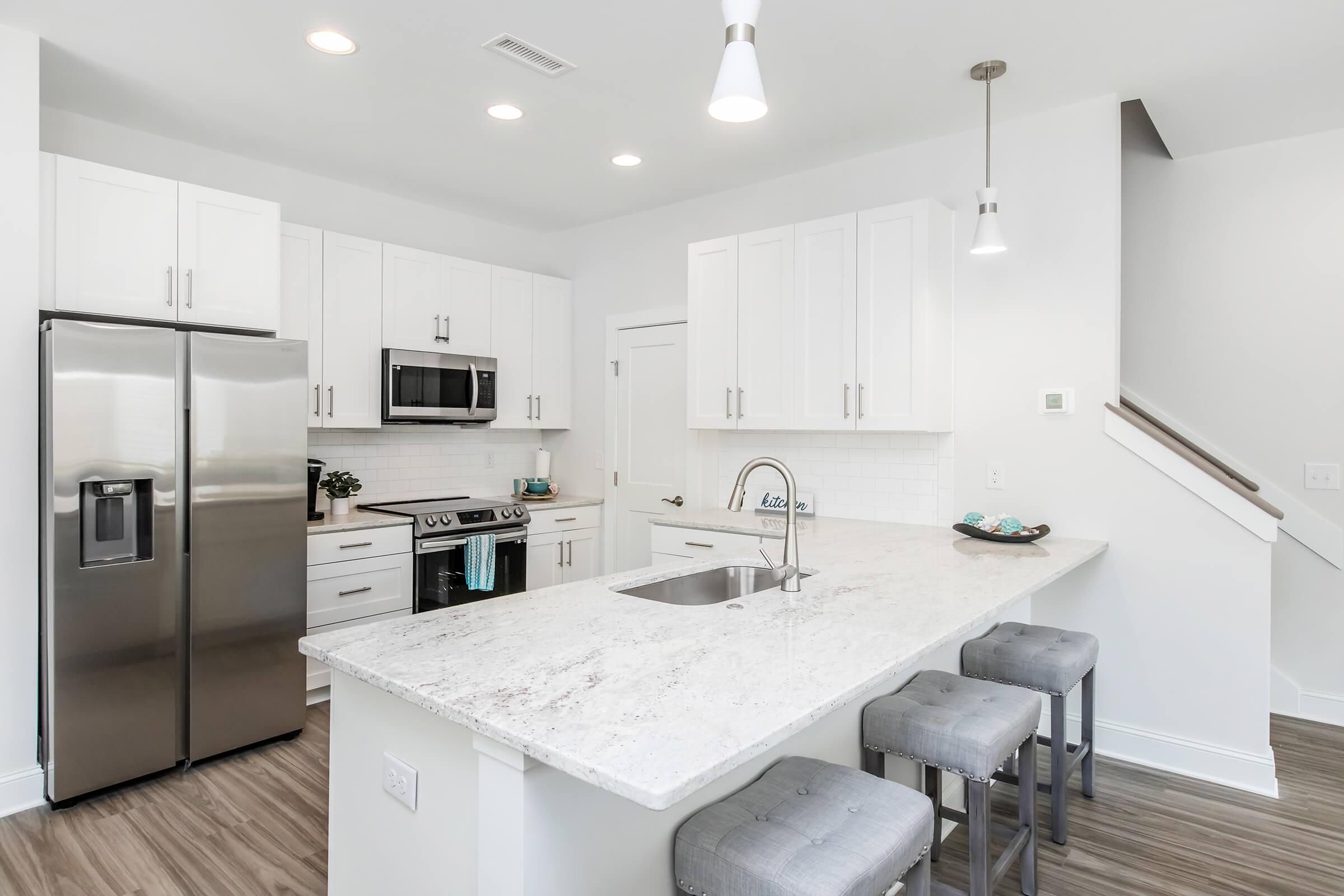 a kitchen with a sink and a refrigerator