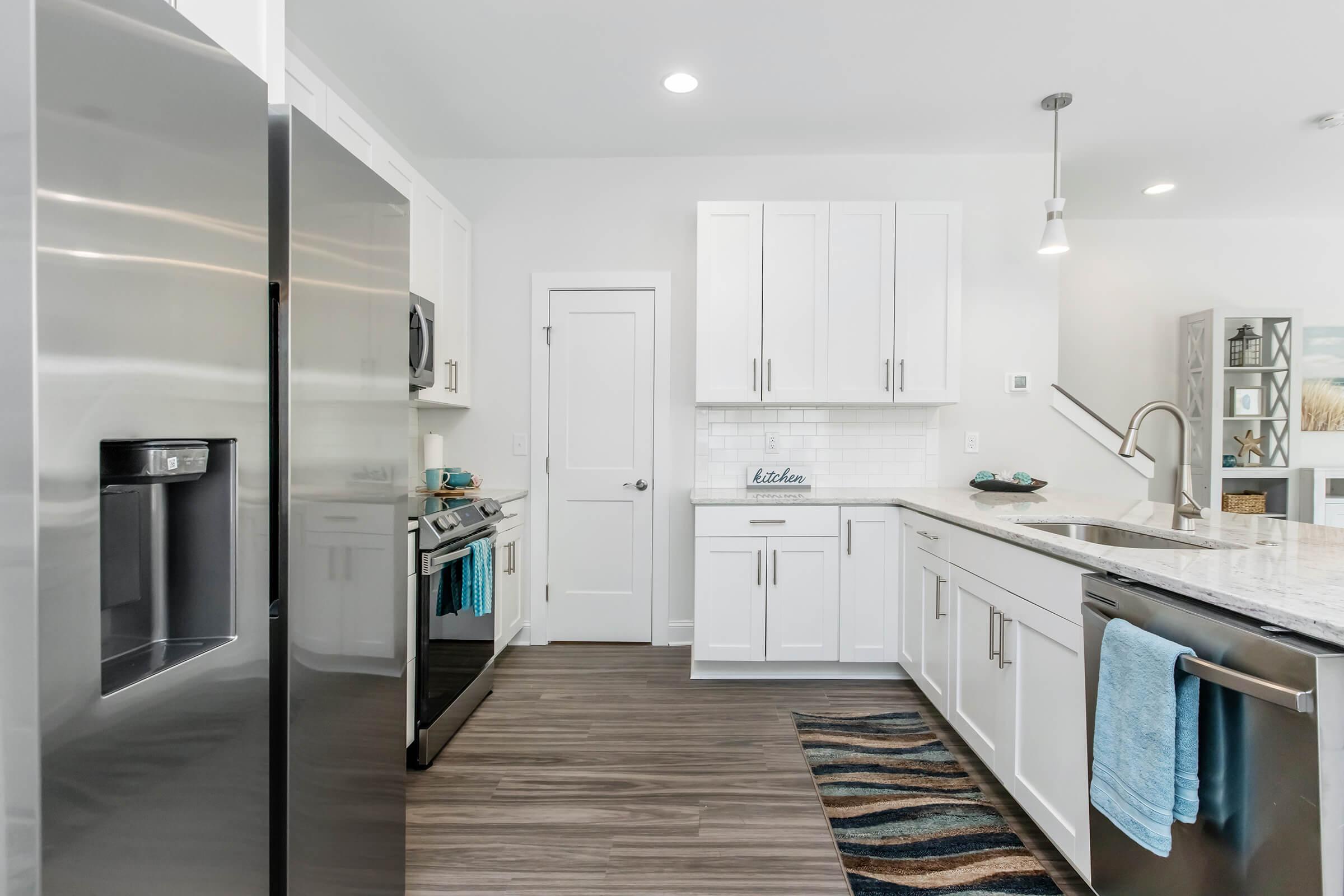 a kitchen with a sink and a refrigerator